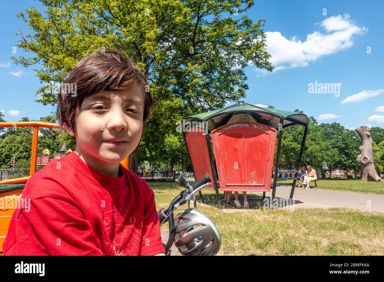 A young boy poses for a portrait in the park. Stock Photo