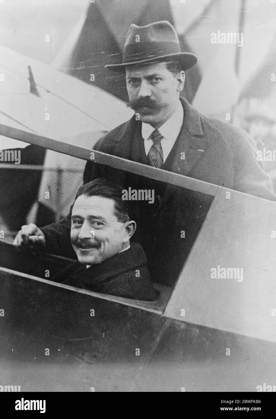 Record Engineless Flight The aviator Maneyrol who has just beaten the Worlds record for engineless flight , remaining in the air for 8 hours 4 minutes and 50 seconds at Vauville near Cherbourg . Maneyrol photographed with Mr Geyret constructor of the machine 5 February 1923 Stock Photo