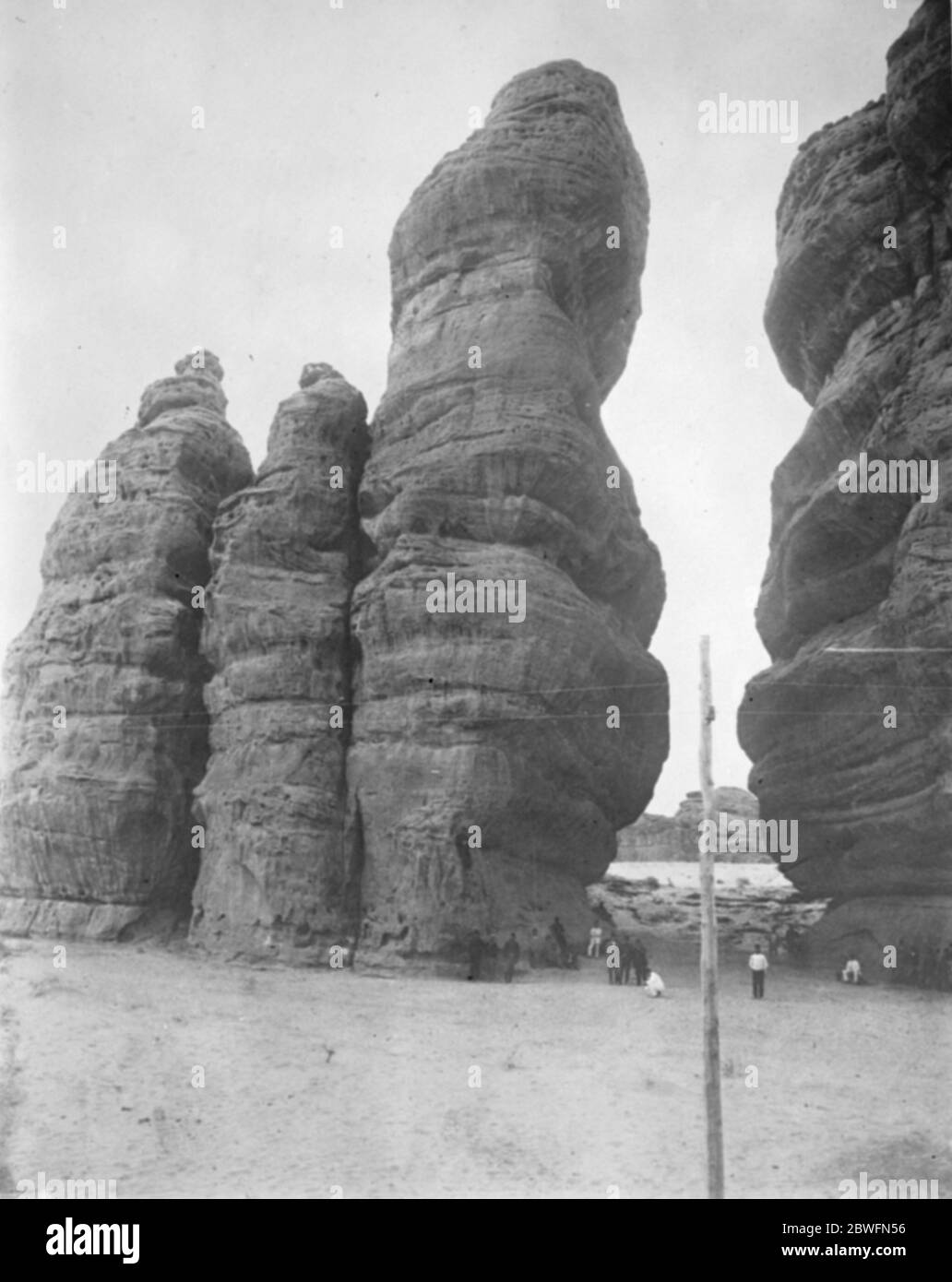 Mecca and Medina . Nabrak en Naka . Near Medain Saleh . Huge sand stone monoliths worn by the friction of sand , carried by the fierce winds which blow in this region .  The place where the camel knelt  . 1925 Stock Photo