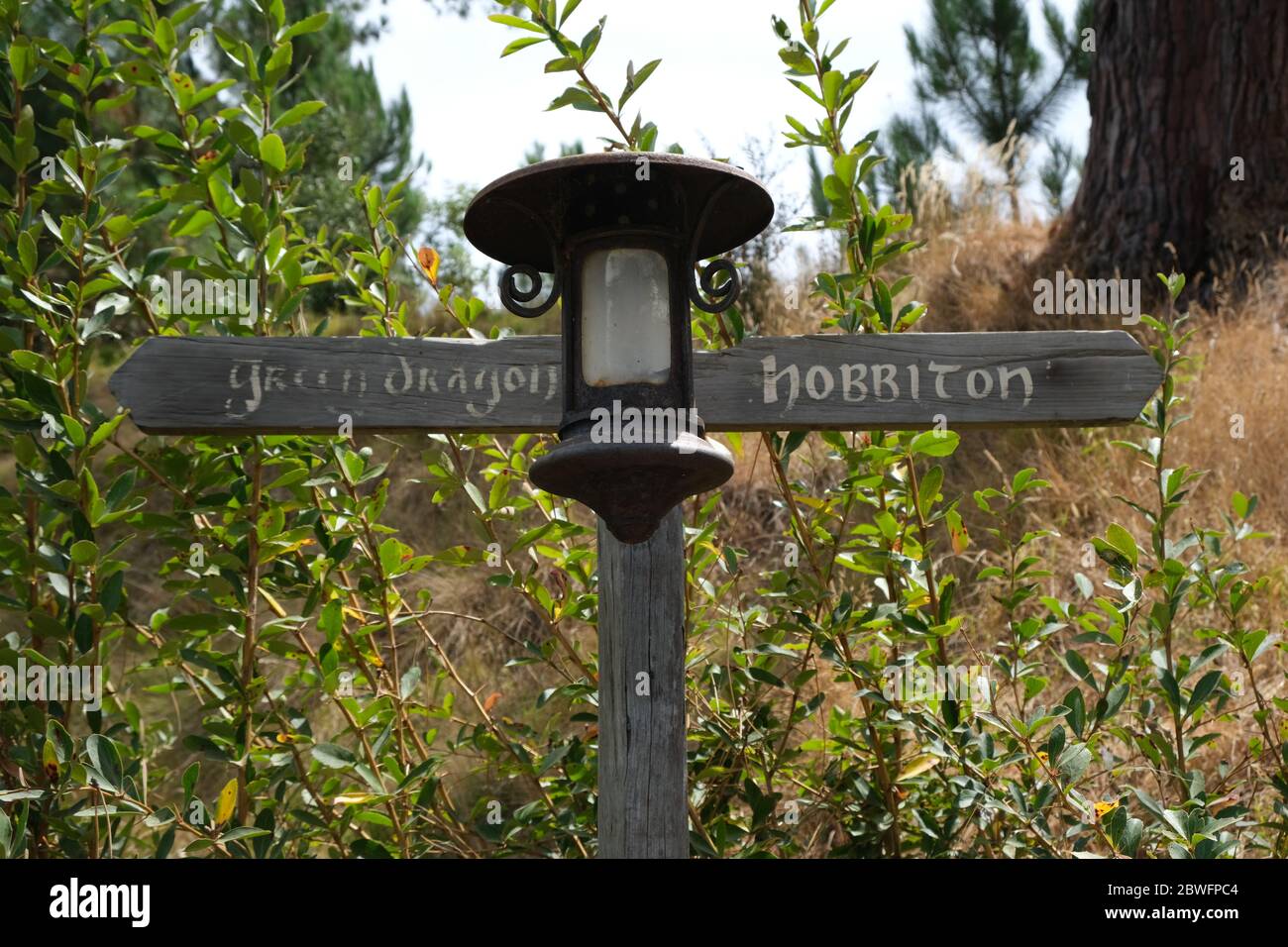 Green Dragon and Hobbiton sign post, New Zealand, Middle Earth Stock Photo