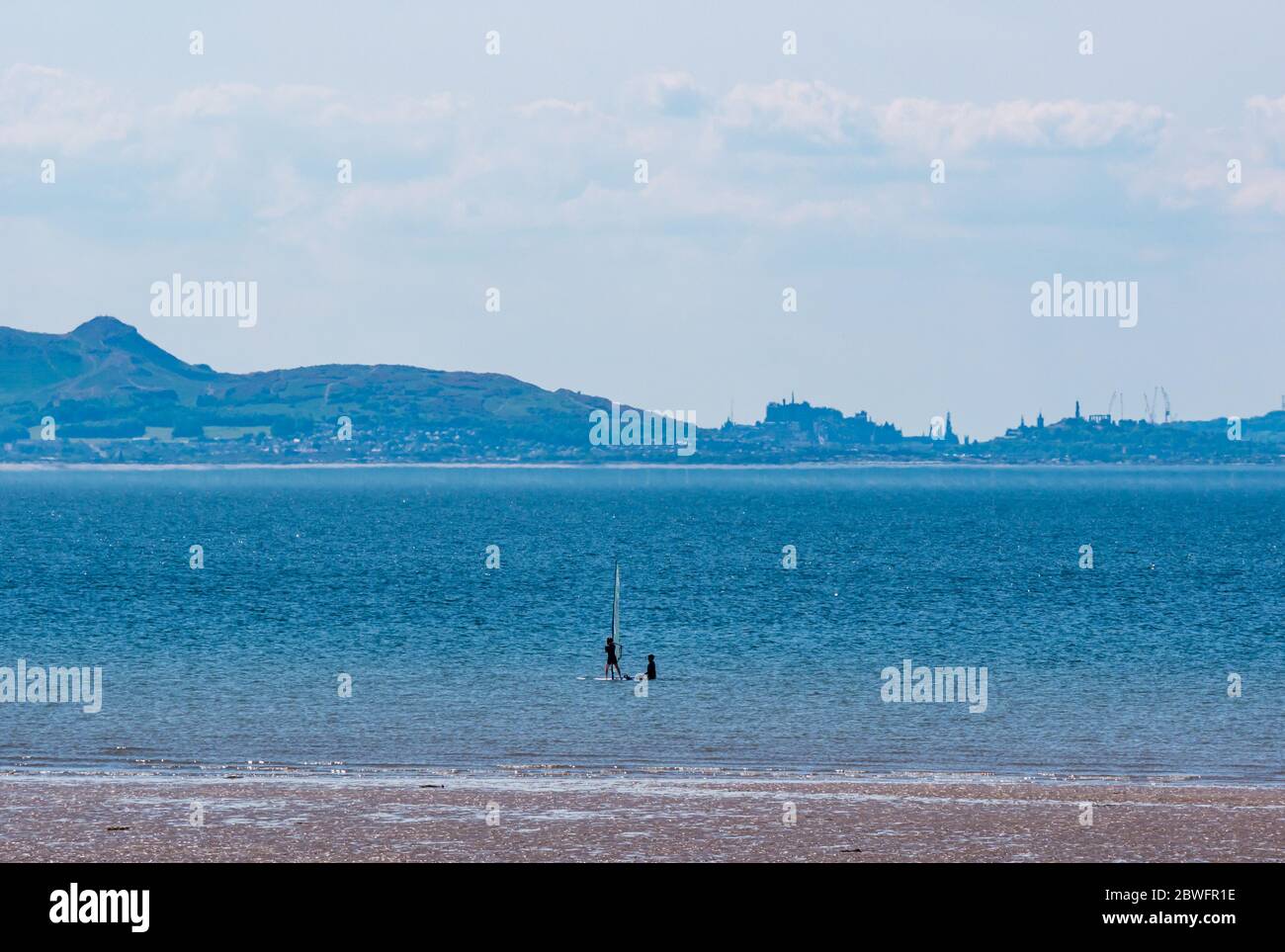 Longniddry Bents, East Lothian, Scotland, United Kingdom, 1st June 2020. UK Weather: hot sunshine at the beach brings people out during the Covid-19 pandemic lockdown. The hazy distinctive outline of Edinburgh is in the distance Stock Photo