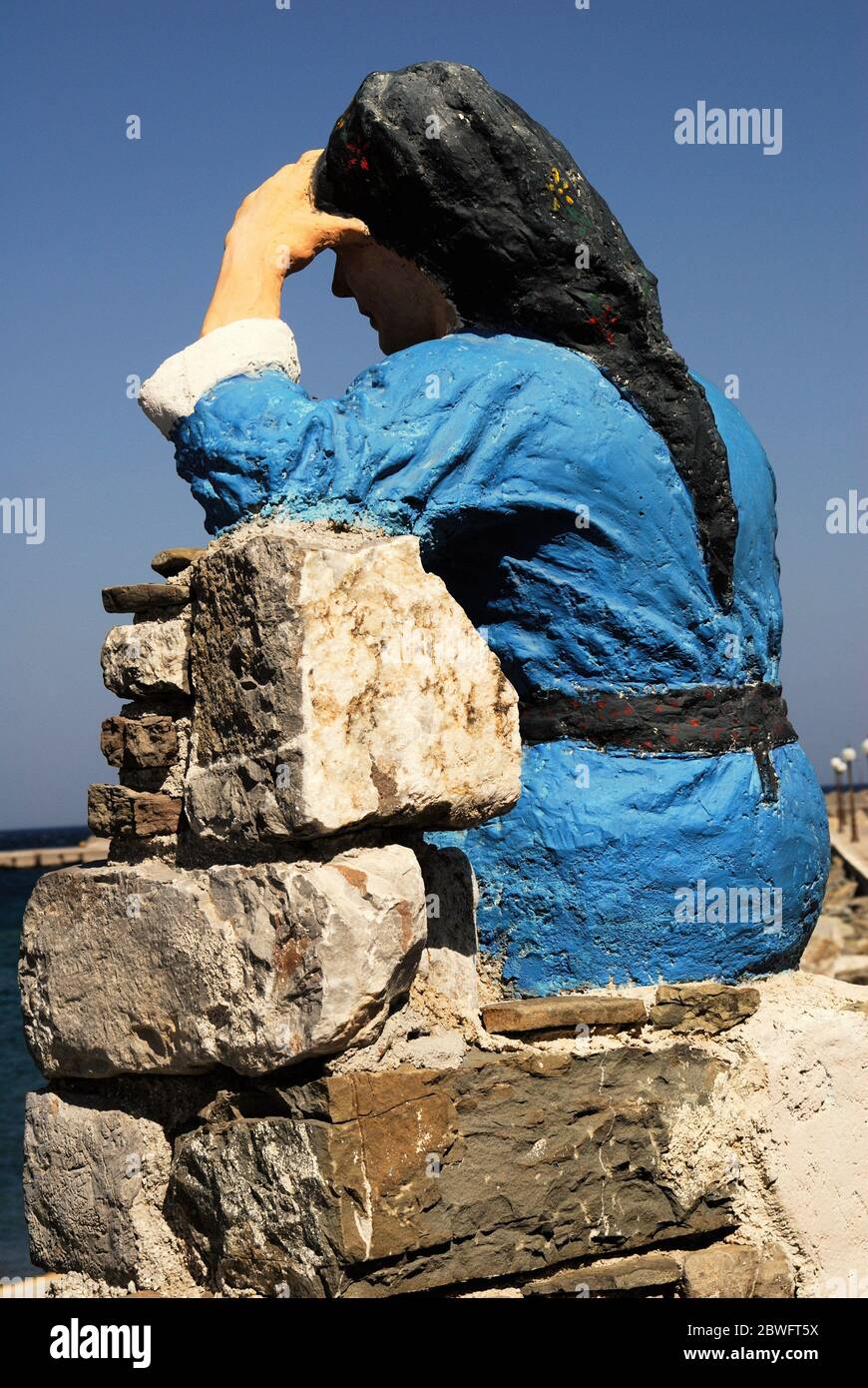 Greece, Karpathos island, statue of woman dressed with traditional costume at the port of Diafani, August 16 2008. Stock Photo