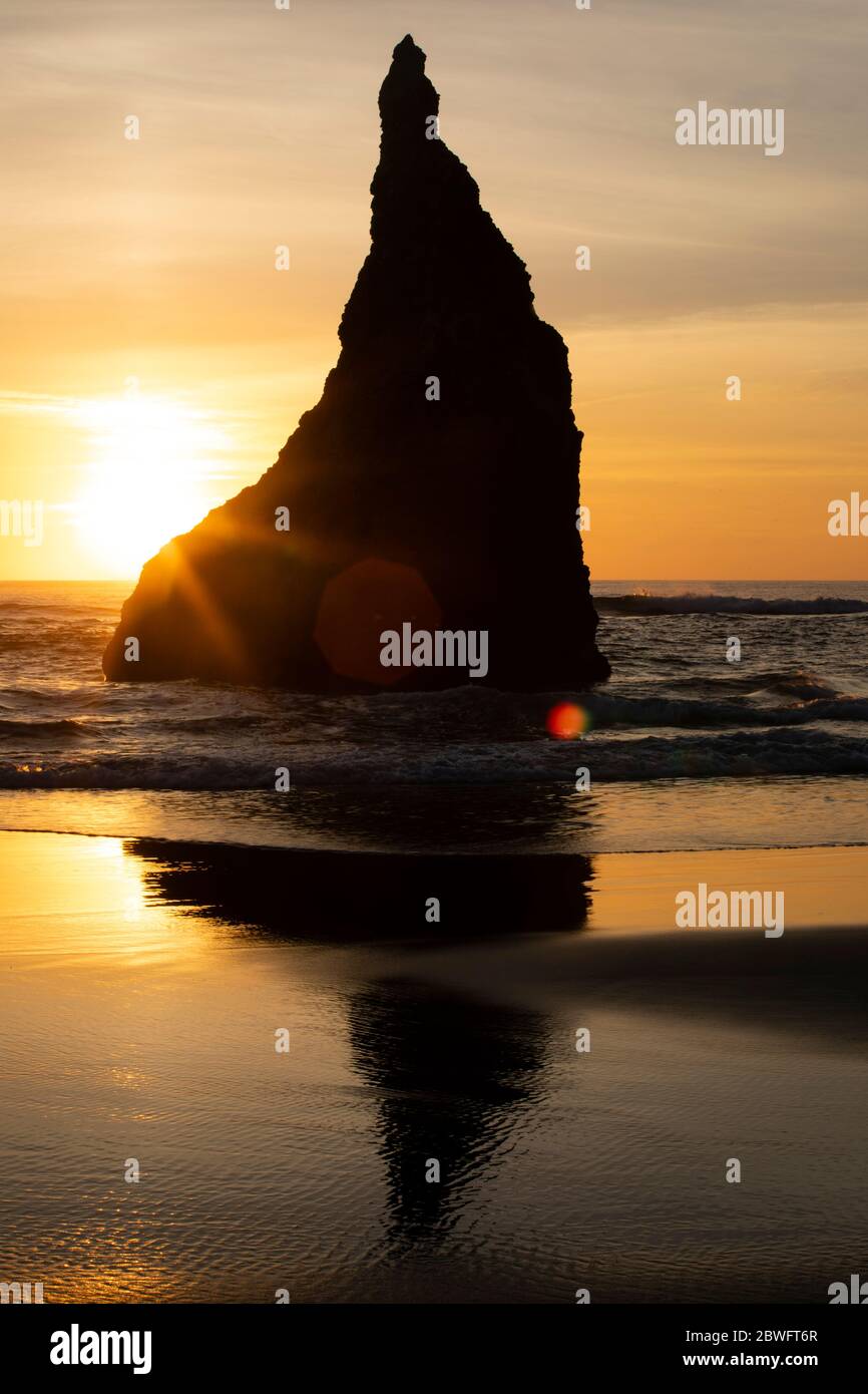 Rock formation in sea seen from Cannon Beach at sunset, Oregon, USA Stock Photo