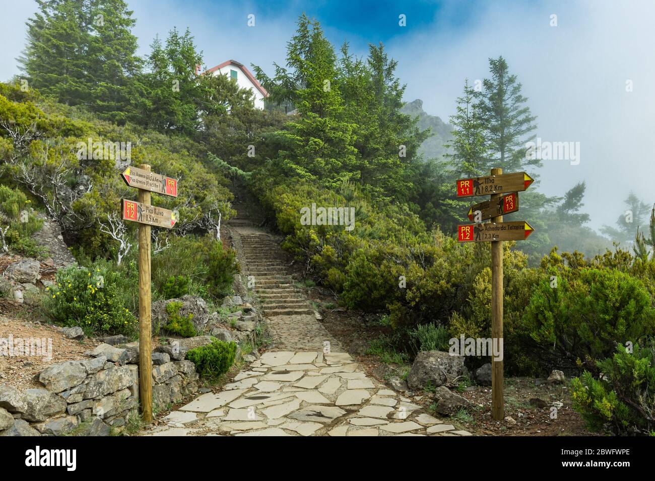 Double directional footpath signs at "Pico Ruivo" peak with shelter ...