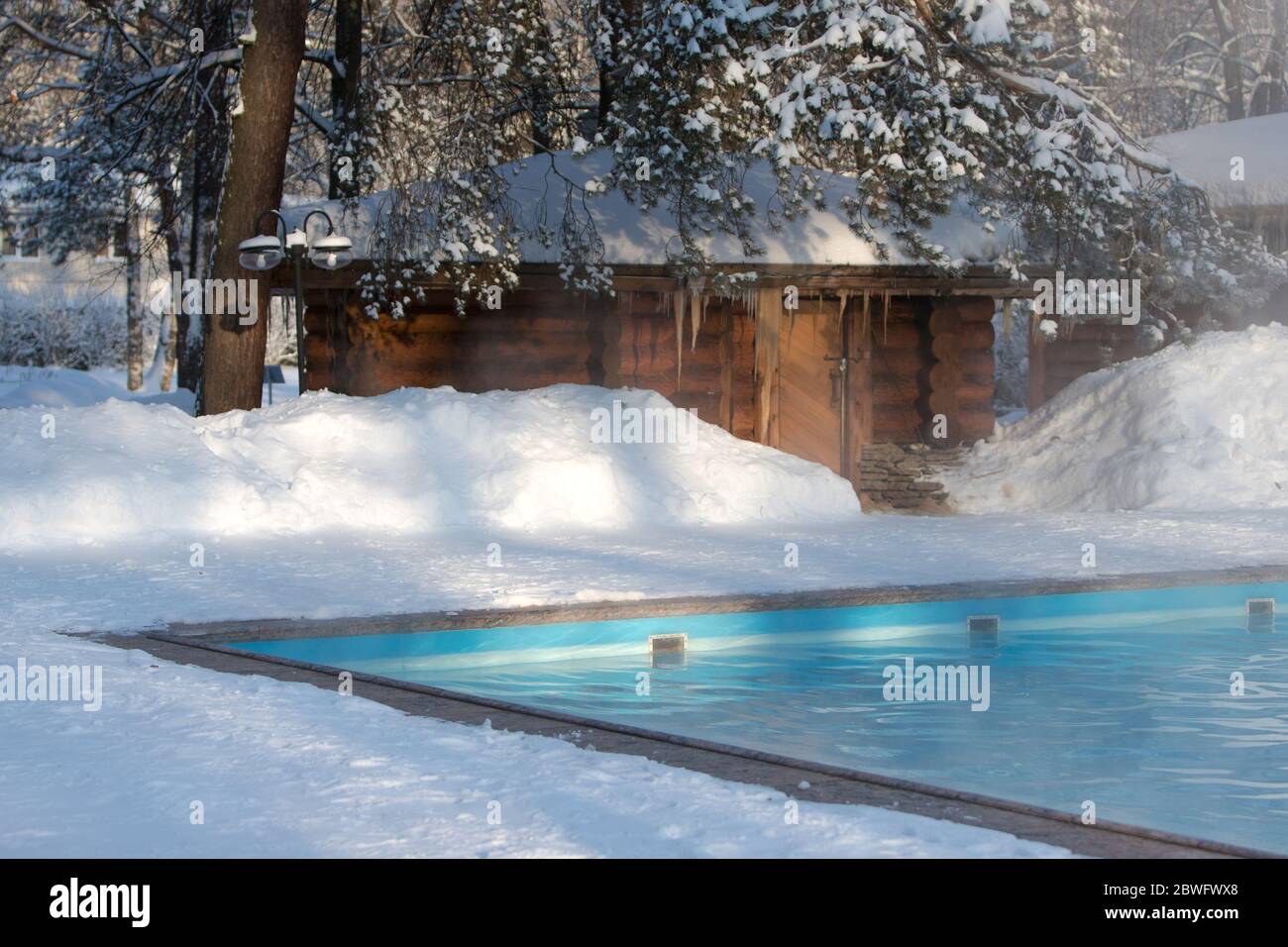 Russian Pool Model Warm swimming pool with blue water and wooden Russian bath in sunny ...