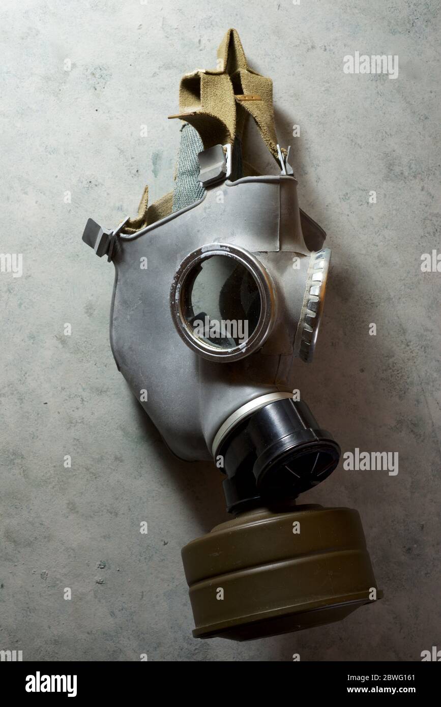Old respiratory mask from the Cold War era, hanging in a wall. Stock Photo