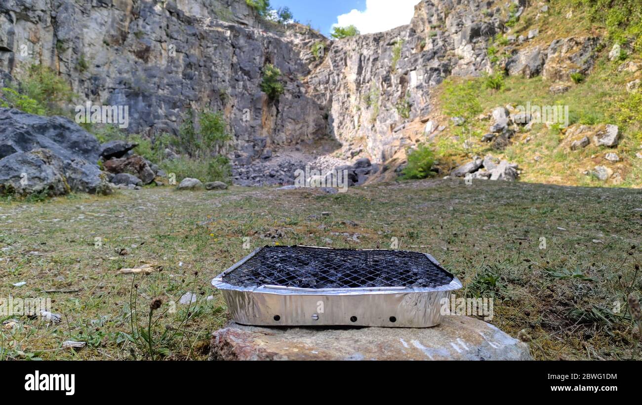 Disposable BBQ dumpted in a quarry at the National Stone Centre, Derbyshire Dales - is it time to ban disposable BBQs? Stock Photo