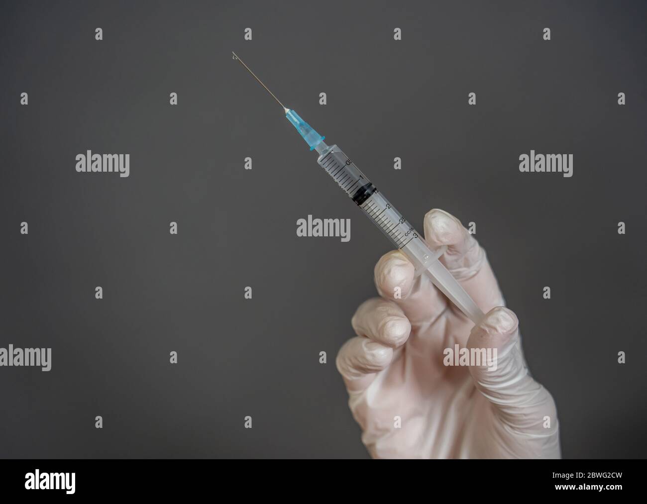 COVID-19 Coronavirus Vaccine. Doctor scientist with syringe analyzing virus Sars-CoV-2 in research for vaccine to be ready for clinical trial. Female Stock Photo