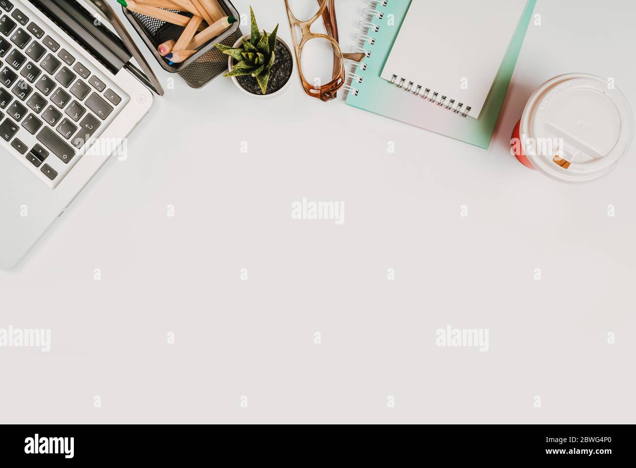 office stuff with with notepad, laptop and coffee, glasses, notepad top view Stock Photo