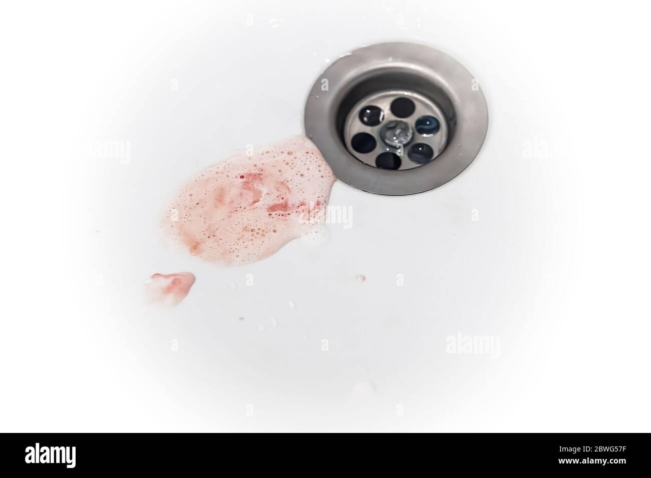 saliva with gum blood and toothpaste after brushing drains into the