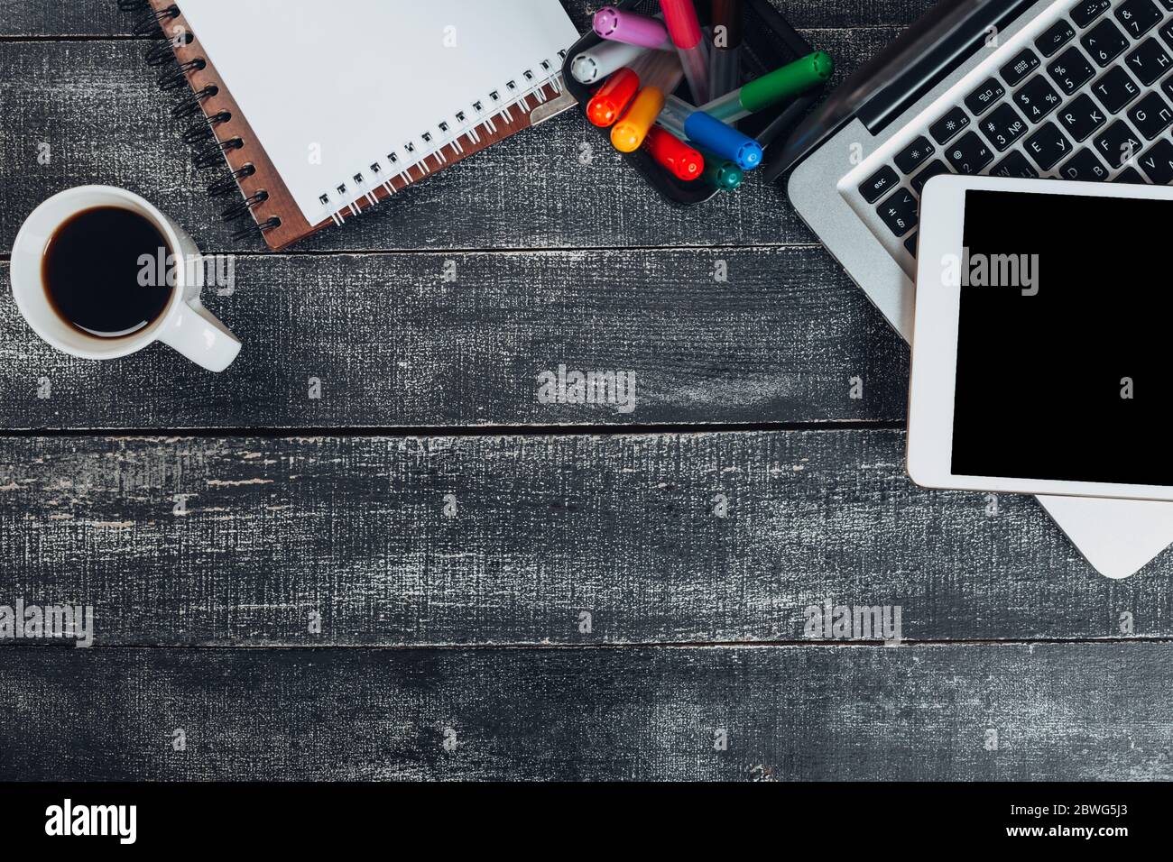 office stuff with notepad, laptop and coffee cup mouse notepad top view shot. Stock Photo
