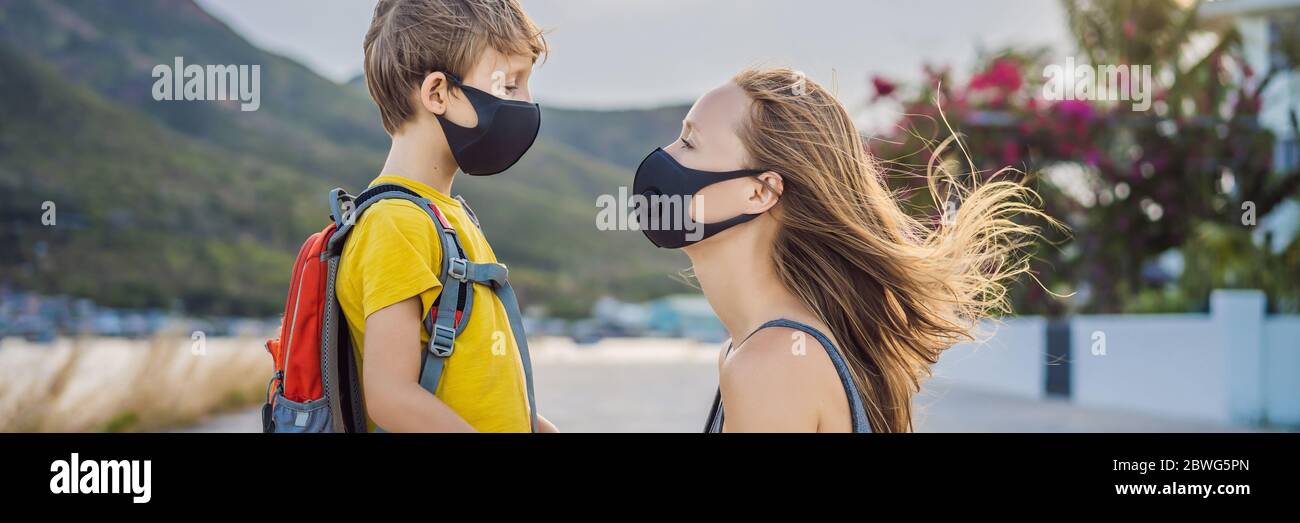 Mother puts her child a face protective mask on the street. Stop the infection. Coronavirus quarantine. Apocalypse. Health care concept. Mask against Stock Photo