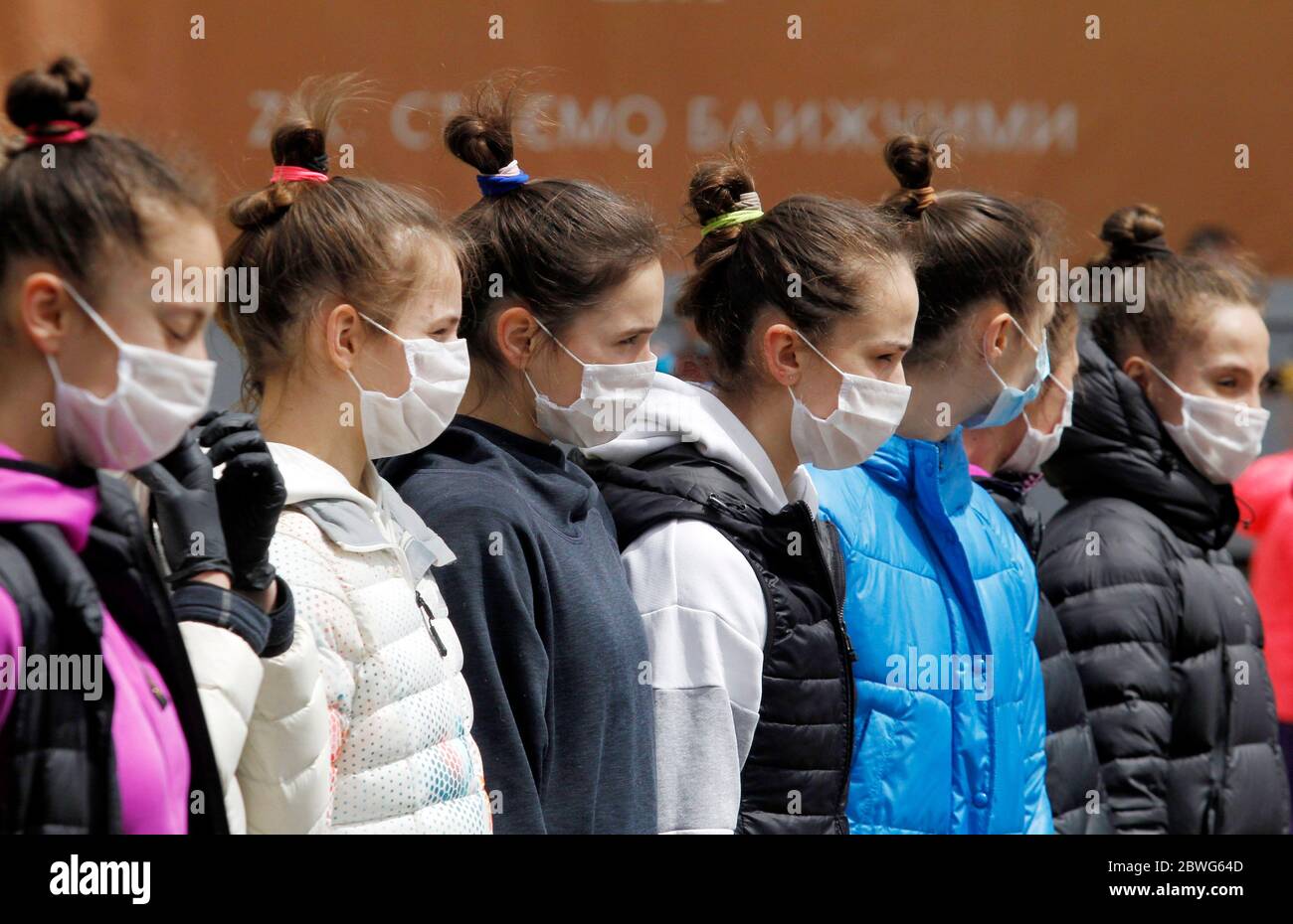 Gymnasts wearing face masks as a preventive measure against the spread of COVID-19 coronavirus attend an open-air training session.Young gymnasts of Ukrainian Deriugina School staged an open-air training session to raise awareness on the situation of the Deriugina School with no building for training, because the rental agreement for the club's training facility expired. The Deriugina School is known rhythmic gymnastics club by the former world champion Irina Deriugina, her coach and mom Albina Deriugina. Irina Deriugina is a former Soviet individual rhythmic gymnast from Ukraine and Ukrainian Stock Photo