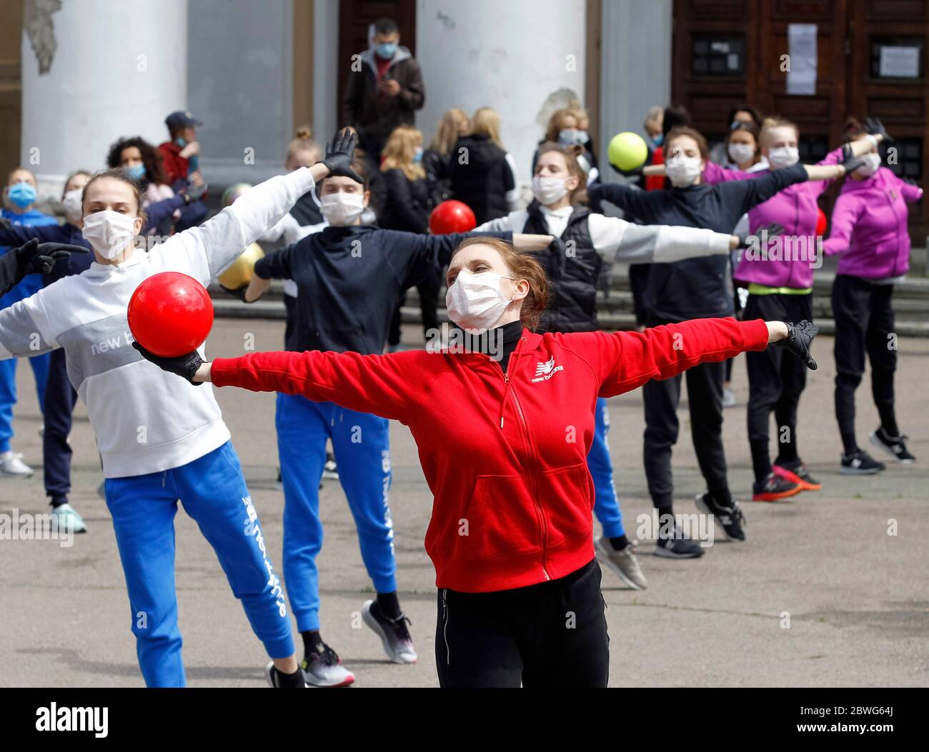Gymnasts wearing face masks as a preventive measure against the spread of COVID-19 coronavirus perform during an open-air training session.Young gymnasts of Ukrainian Deriugina School staged an open-air training session to raise awareness on the situation of the Deriugina School with no building for training, because the rental agreement for the club's training facility expired. The Deriugina School is known rhythmic gymnastics club by the former world champion Irina Deriugina, her coach and mom Albina Deriugina. Irina Deriugina is a former Soviet individual rhythmic gymnast from Ukraine and U Stock Photo
