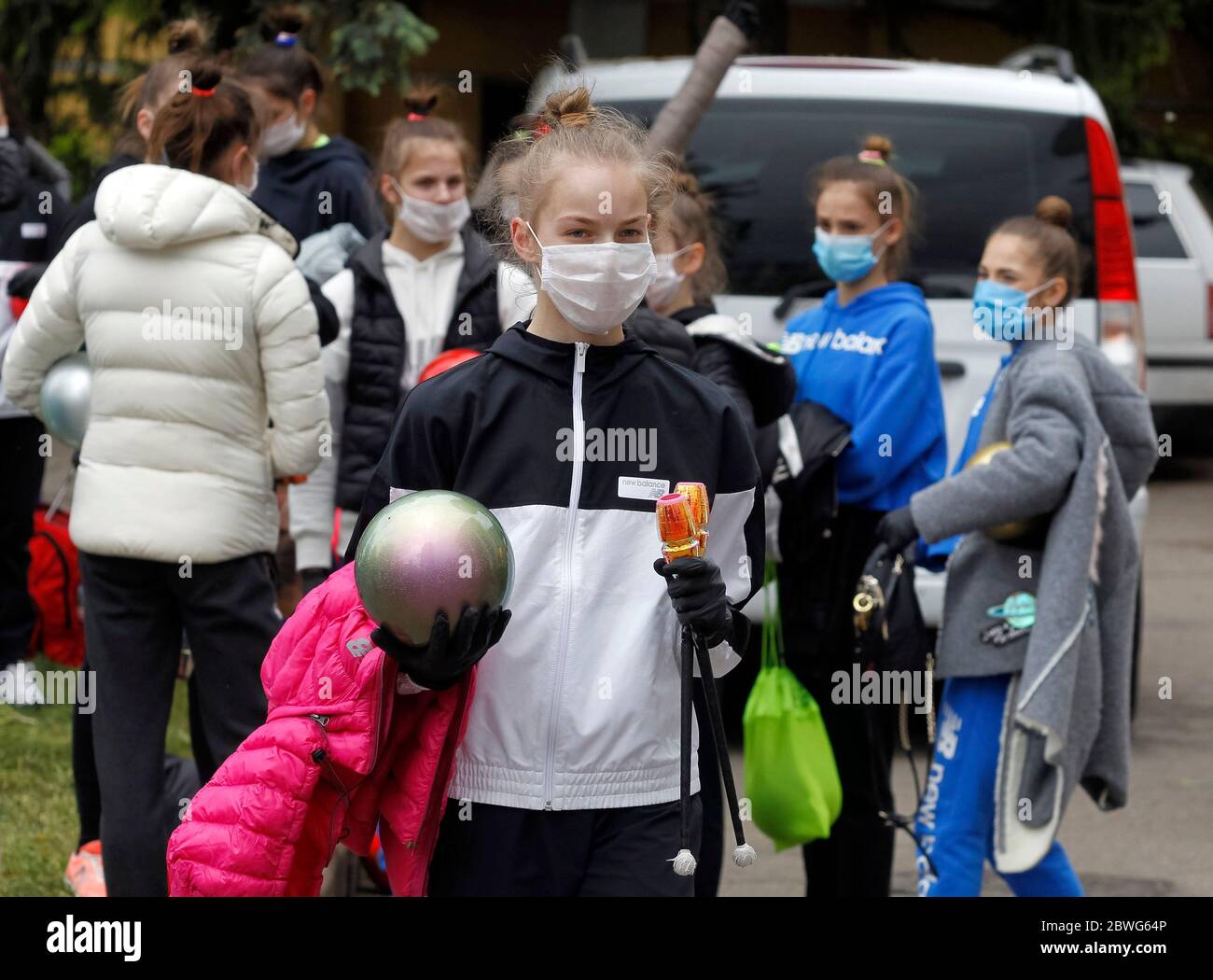 Gymnasts wearing face masks as a preventive measure against the spread of COVID-19 coronavirus attend an open-air training session.Young gymnasts of Ukrainian Deriugina School staged an open-air training session to raise awareness on the situation of the Deriugina School with no building for training, because the rental agreement for the club's training facility expired. The Deriugina School is known rhythmic gymnastics club by the former world champion Irina Deriugina, her coach and mom Albina Deriugina. Irina Deriugina is a former Soviet individual rhythmic gymnast from Ukraine and Ukrainian Stock Photo