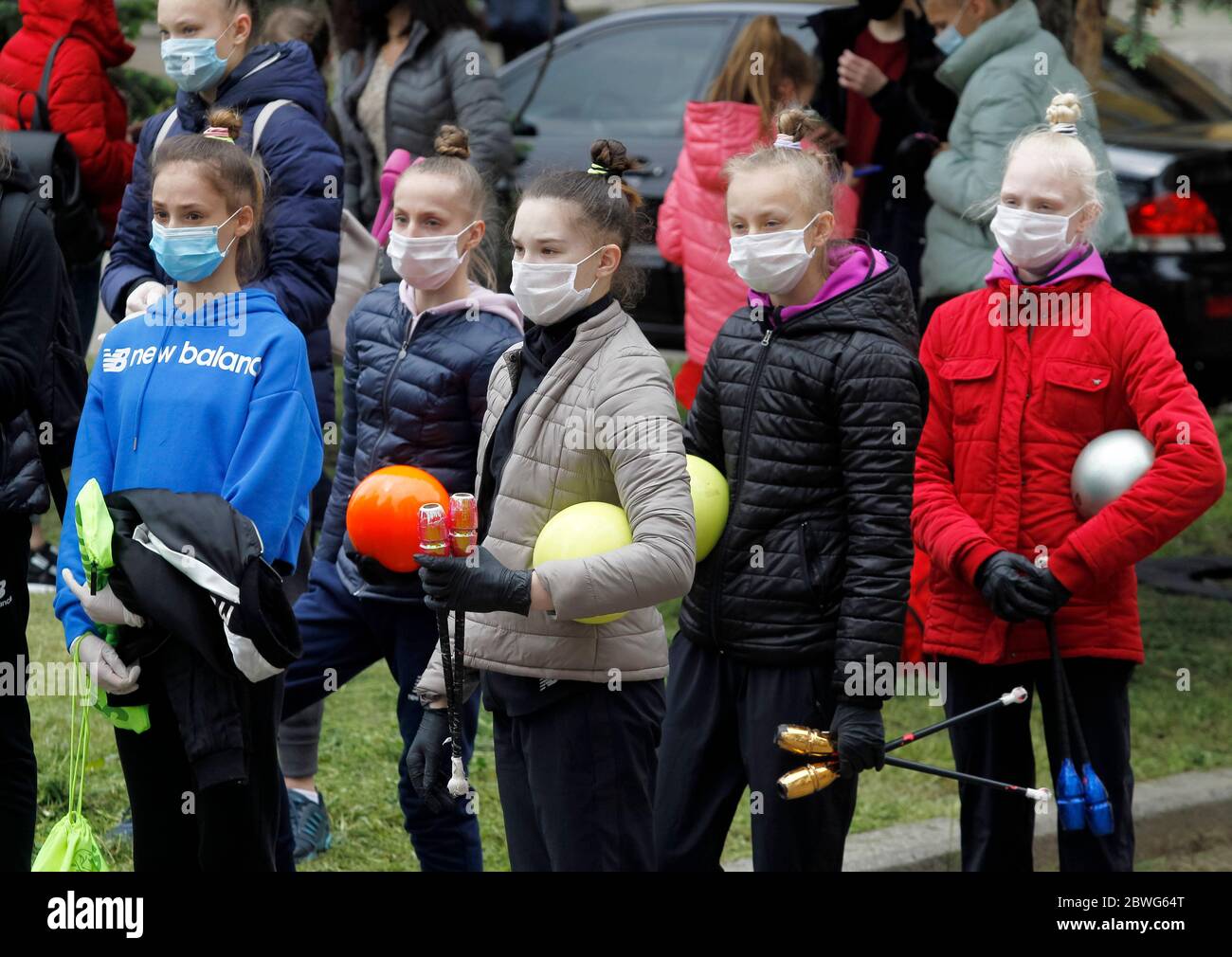 Gymnasts wearing face masks as a preventive measure against the spread of COVID-19 coronavirus attend an open-air training session.Young gymnasts of Ukrainian Deriugina School staged an open-air training session to raise awareness on the situation of the Deriugina School with no building for training, because the rental agreement for the club's training facility expired. The Deriugina School is known rhythmic gymnastics club by the former world champion Irina Deriugina, her coach and mom Albina Deriugina. Irina Deriugina is a former Soviet individual rhythmic gymnast from Ukraine and Ukrainian Stock Photo