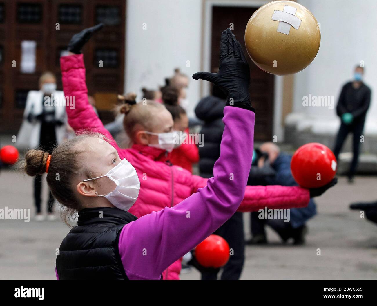 Gymnasts wearing face masks as a preventive measure against the spread of  COVID-19 coronavirus perform during an open-air training session.Young  gymnasts of Ukrainian Deriugina School staged an open-air training session  to raise