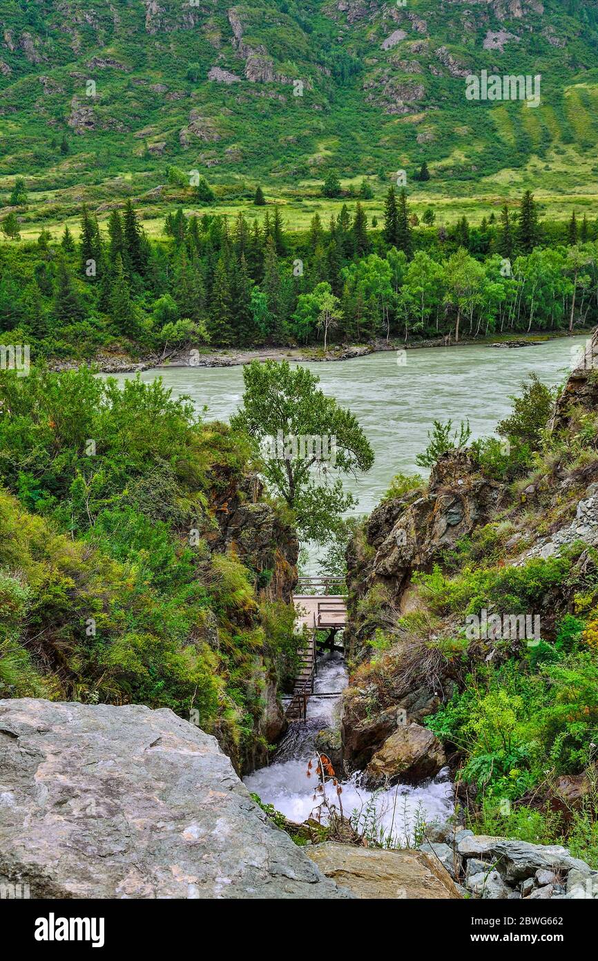 Wonderful nature of Altai mountains - gorge with Beltertuyuk waterfall, flowing into the Katun river. Beauty and purity of mountain nature, rapid stre Stock Photo