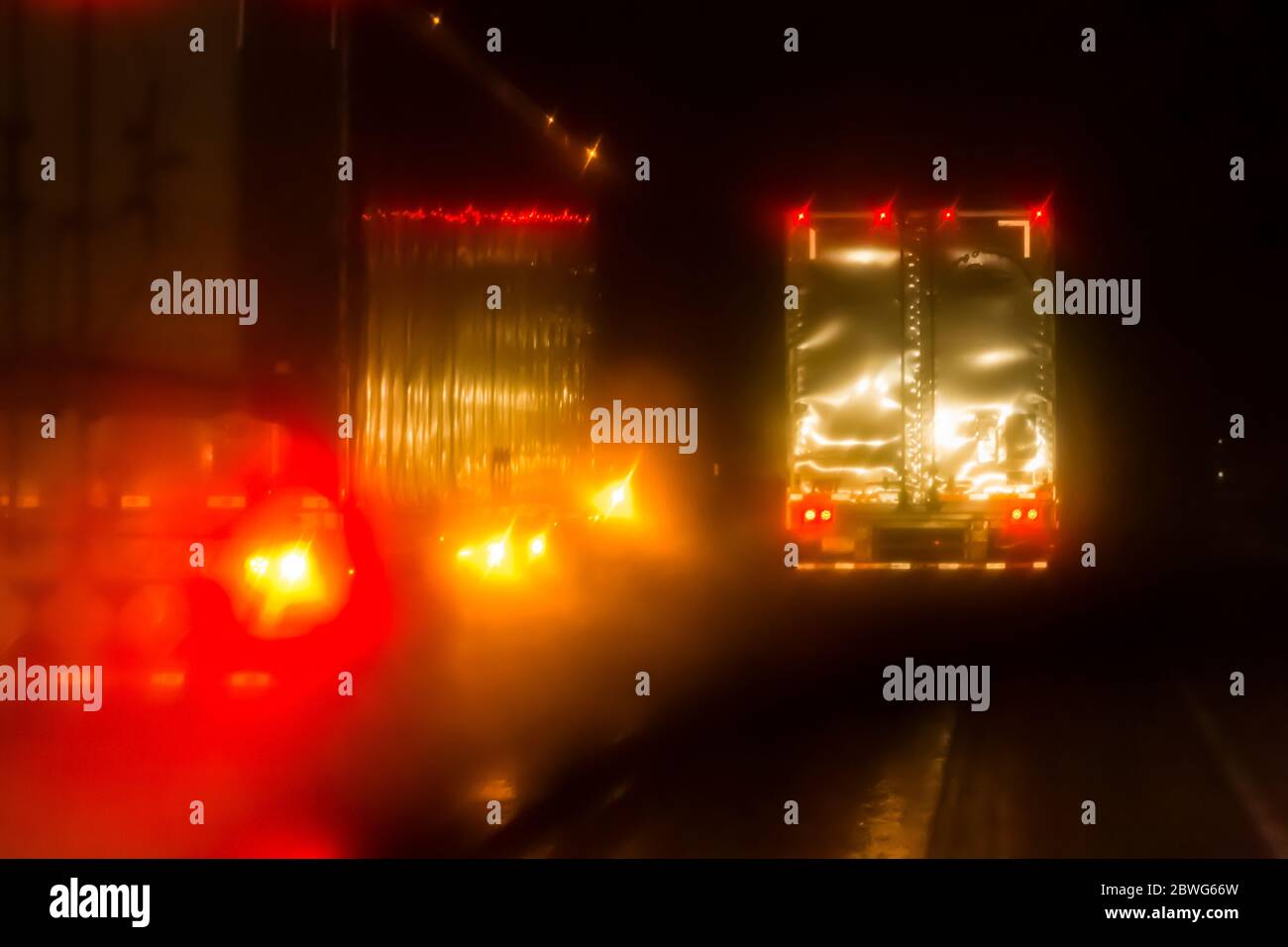 Semi trucks on Interstate 84 over the Blue Mountains on a rainy November night, Oregon, USA [No property release; available for editorial licensing on Stock Photo