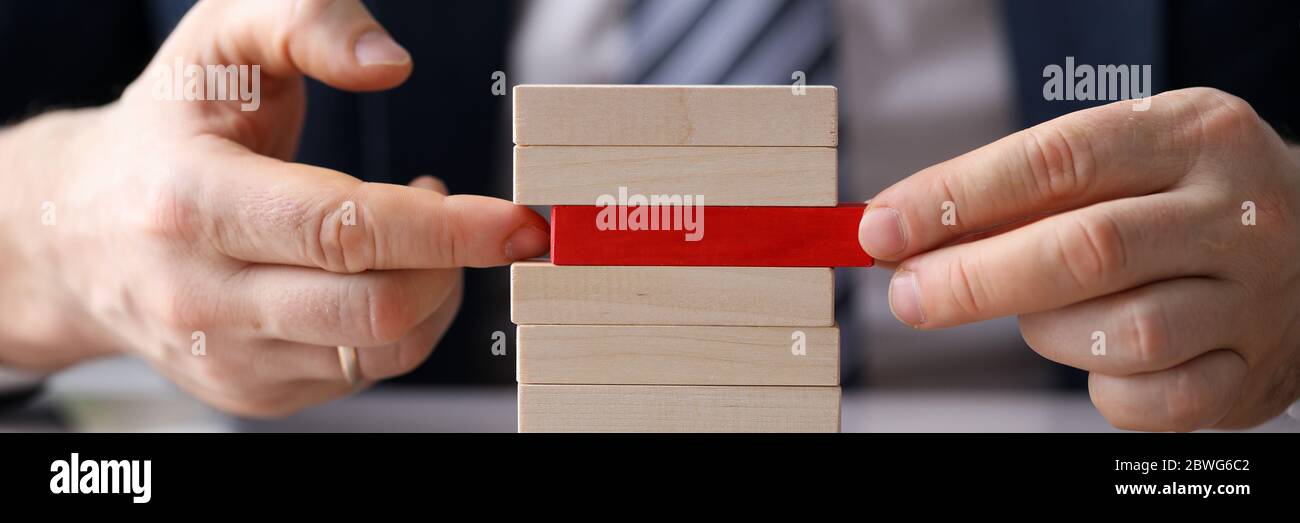 Man plays board game building from wooden blocks Stock Photo Alamy