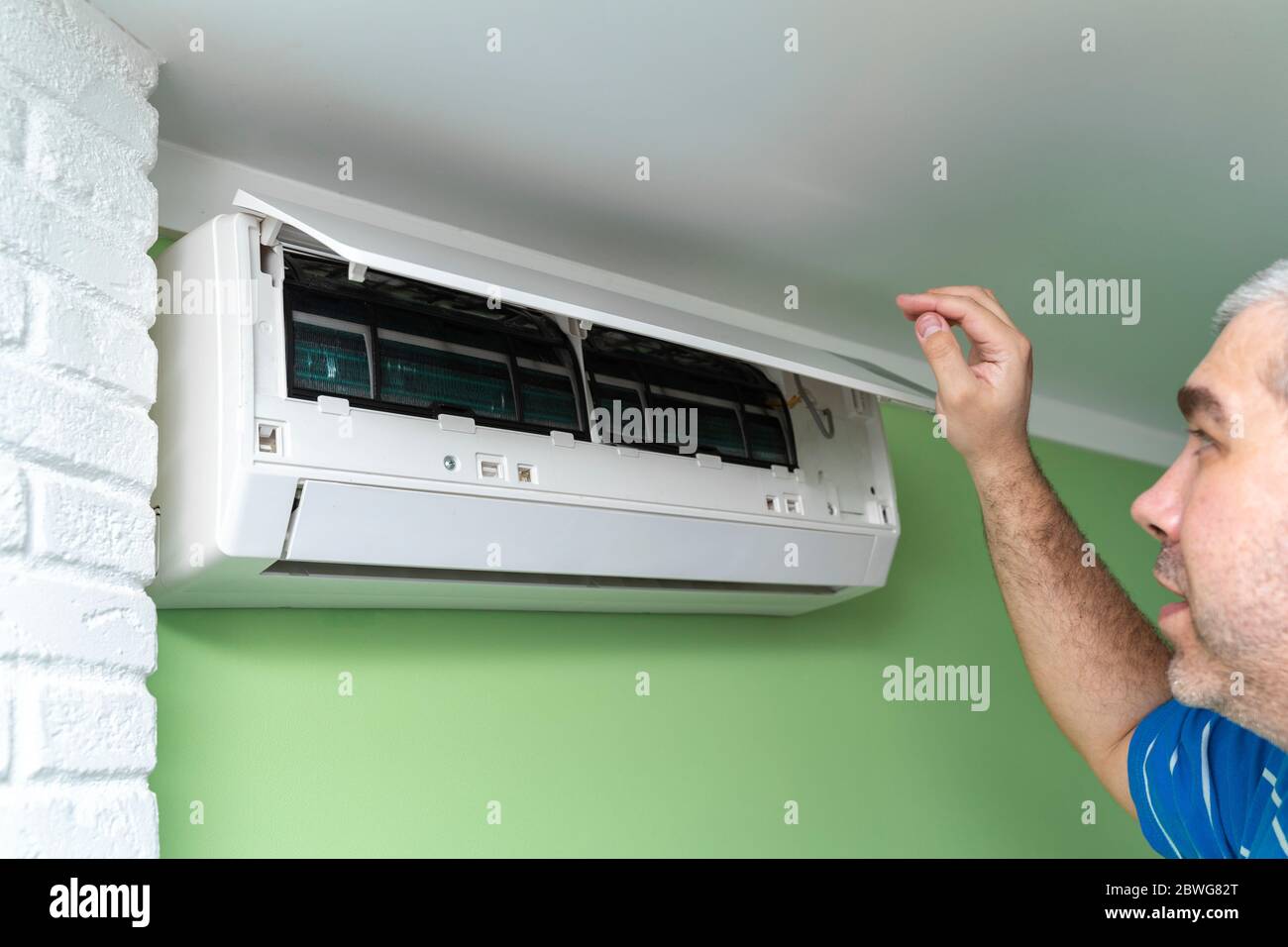 Male technician repairing and reading air conditioners. Opening the lid