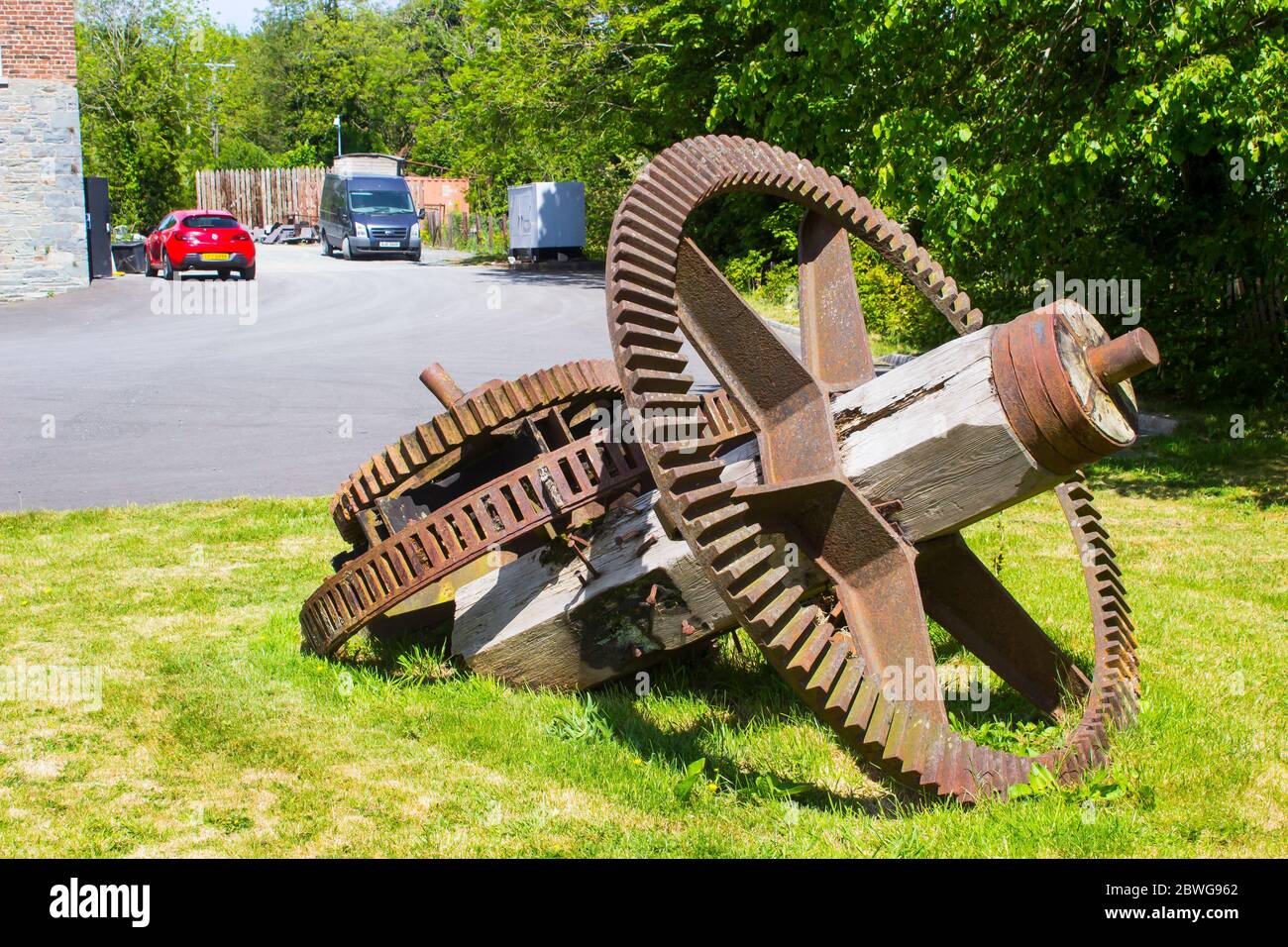 The ancient water wheel drive gear mechanism from the Ballydugan Flour Mill near Downpatrik County Down Northern ireland now used as garden ornaments. Stock Photo