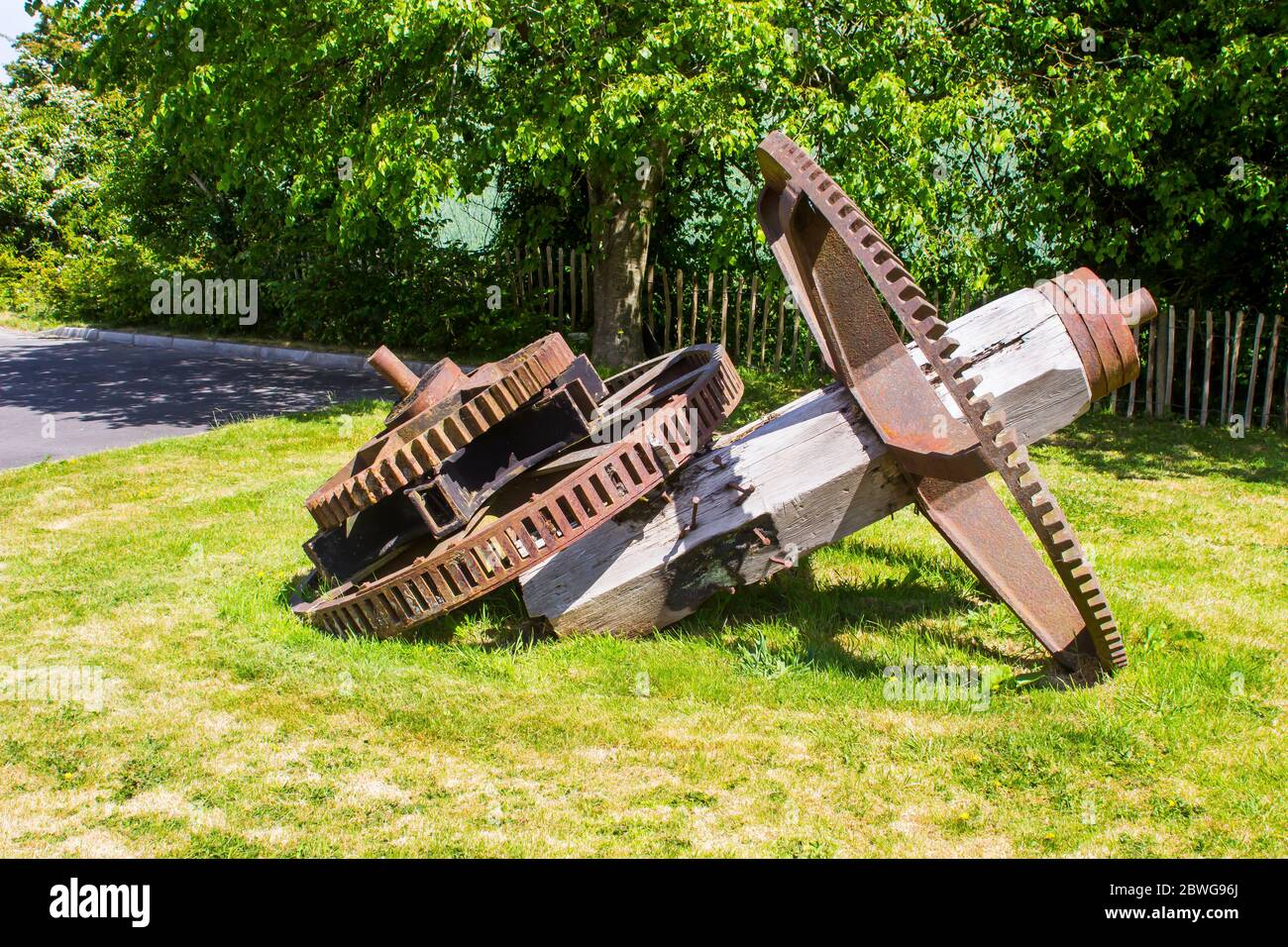 The ancient water wheel drive gear mechanism from the Ballydugan Flour Mill near Downpatrik County Down Northern ireland now used as garden ornaments. Stock Photo