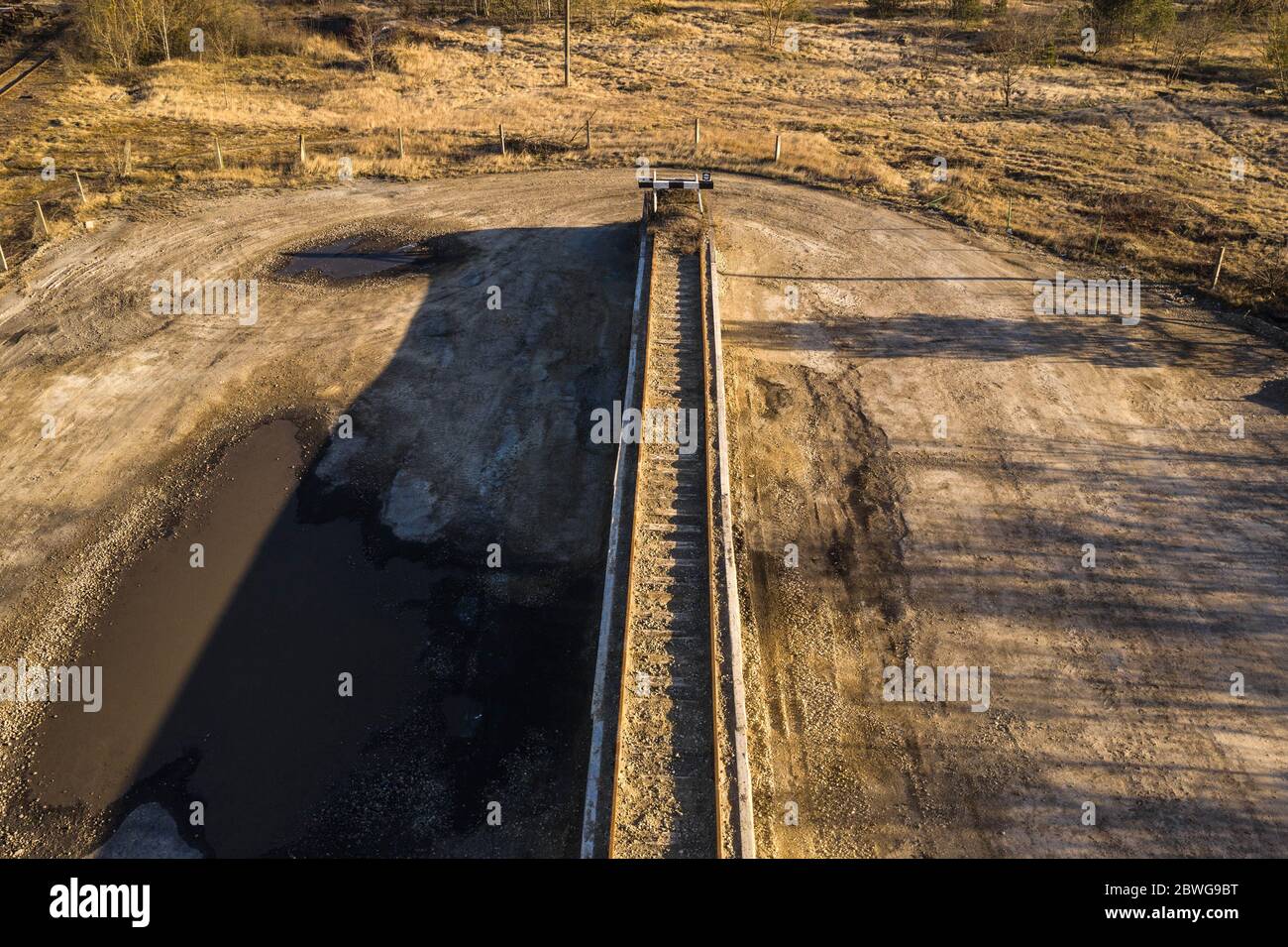 Drone view of old rusty railway track on an platform during summer day. Stock Photo