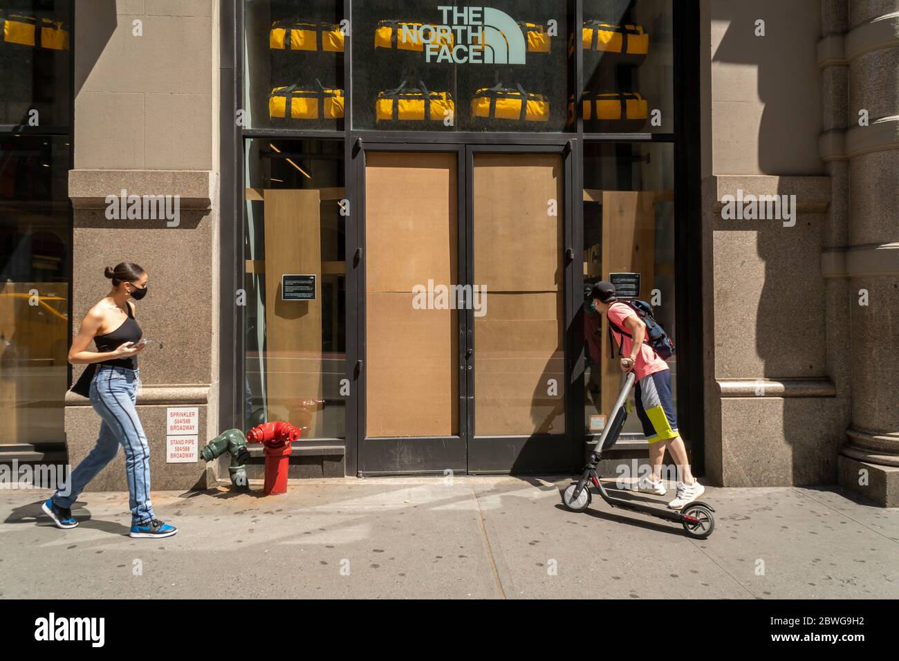 Vandalized North Face store in Soho in New York is boarded up after  vandalization and looting during the previous night's protests related to  the death of George Floyd, seen on Sunday, May
