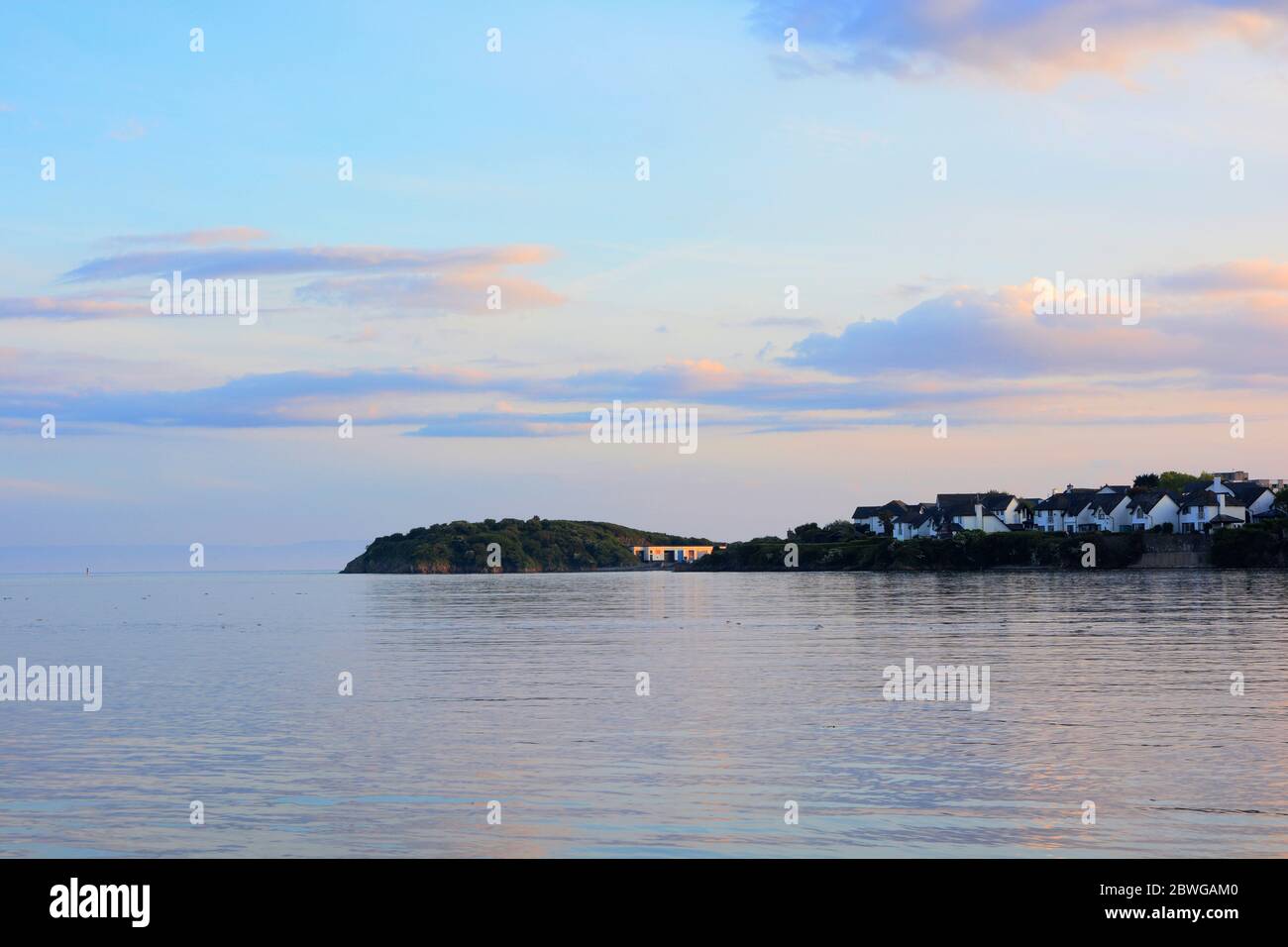 Barry, Wales, The causeway and point at Barry Island on the horizon. High tide with the sun