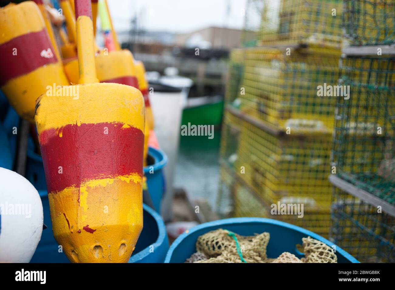 Bright colored buoys in selective focus alongside other equipment and
