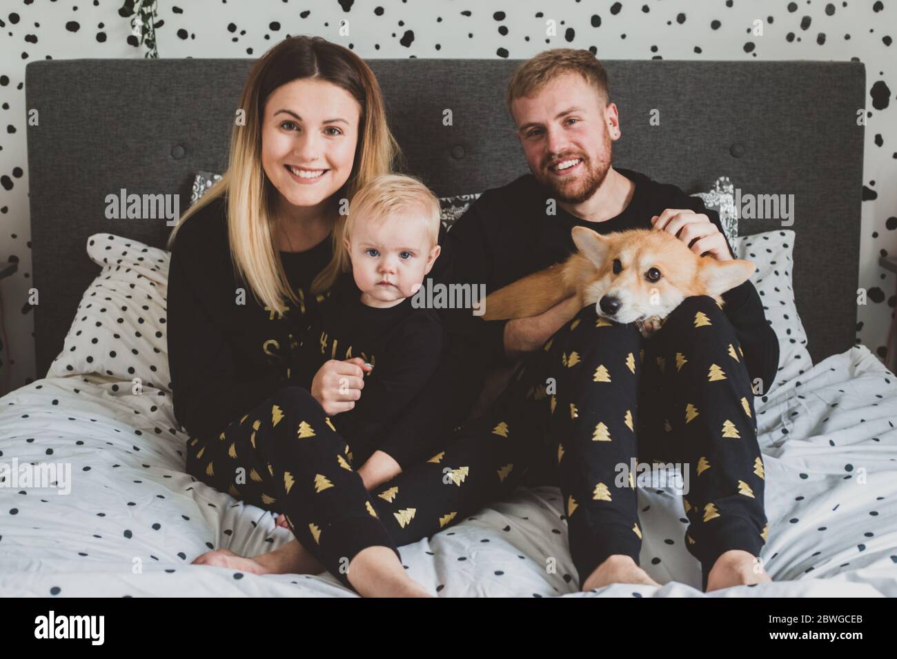Young family wearing matching christmas pyjamas Stock Photo