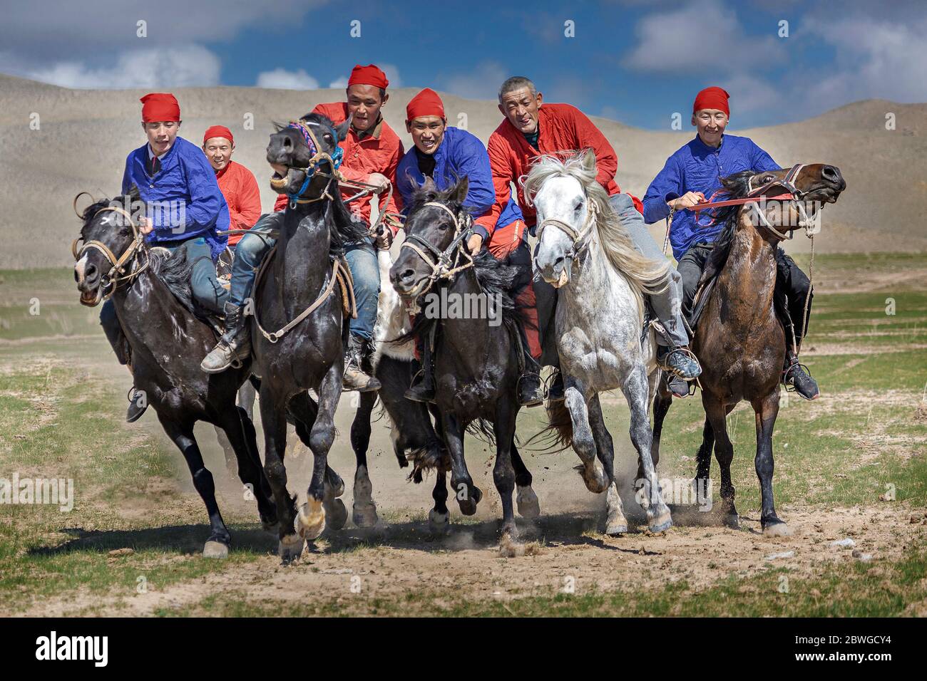 Nomad horse riders playing traditional nomadic horse game of Buzkashi known also as Kokpar, in Issyk Kul, Kyrgyzstan Stock Photo
