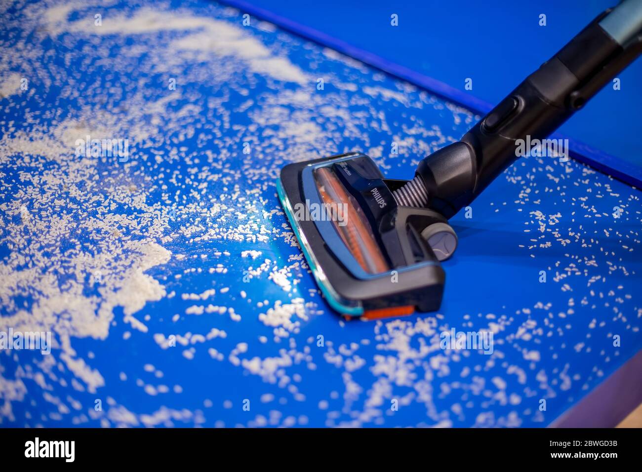 Moscow, Russia - October 04, 2019: a new vacuum cleaner philips SpeedPro  aqua with wet cleaning and LEDs cleans the blue floor from white crumbs  Stock Photo - Alamy