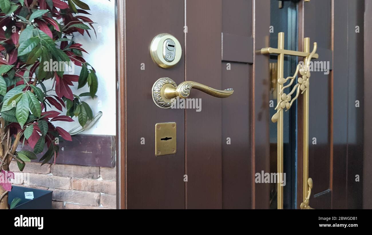 Door handle, door lock. The entrance metal armored door is half open to