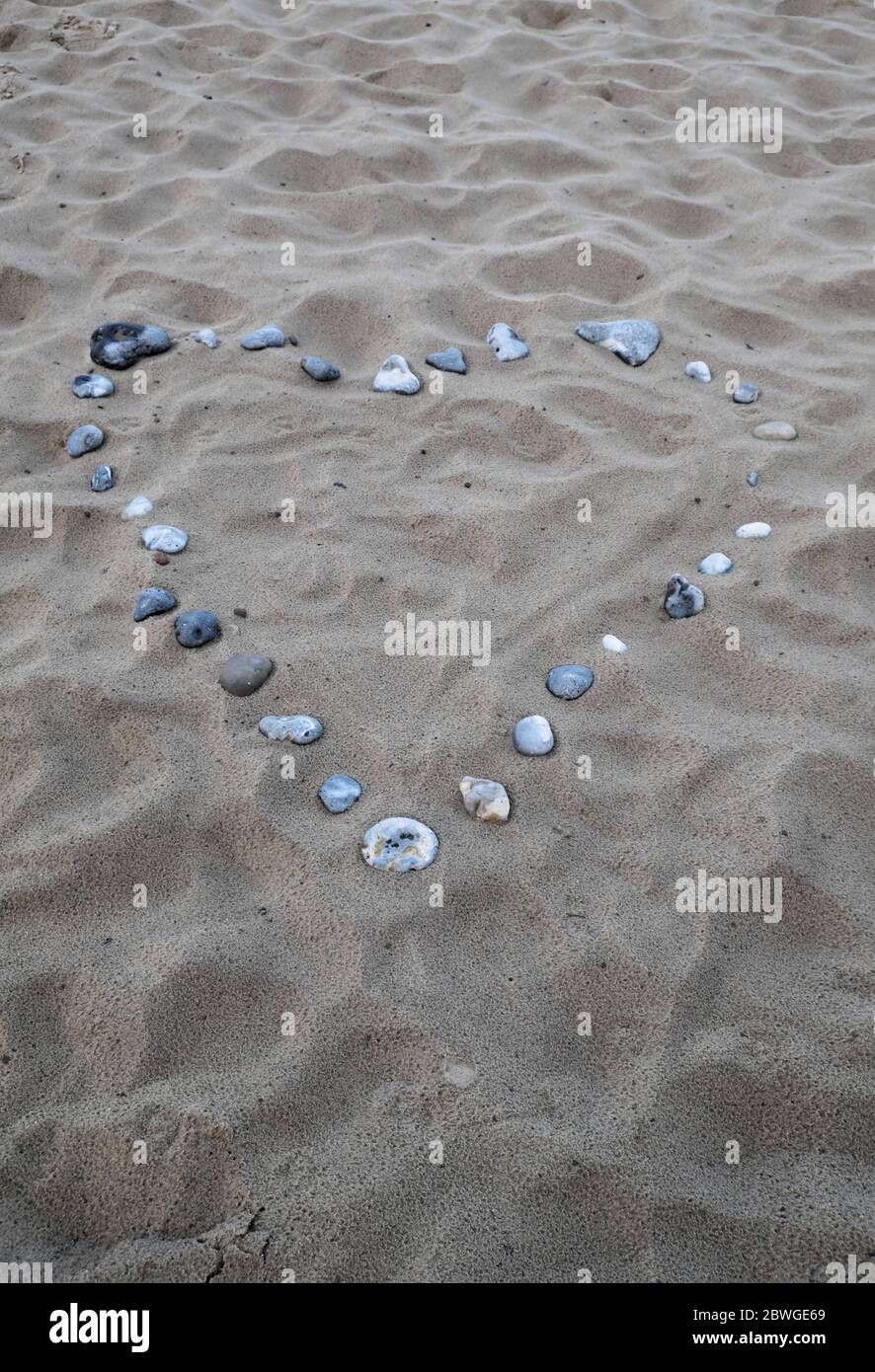 A romantic heart made out of pebbles on the beach at Troon Ayrshire Scotland UK Stock Photo