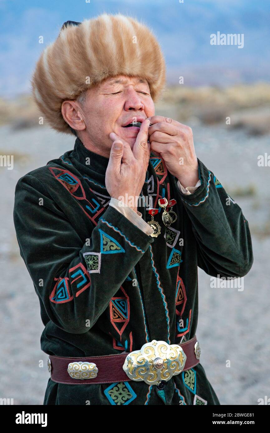 Kyrgyz musician playing traditional musical instrument known as Timur Komuz, a version of Jew's harp, in Issyk Kul, Kyrgyzstan Stock Photo