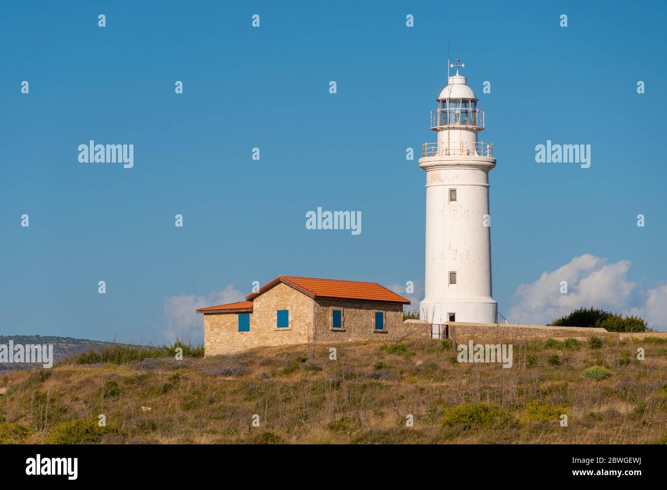 White lighthouse overlooking the harbour in Paphos, Republic of Cyprus Stock Photo