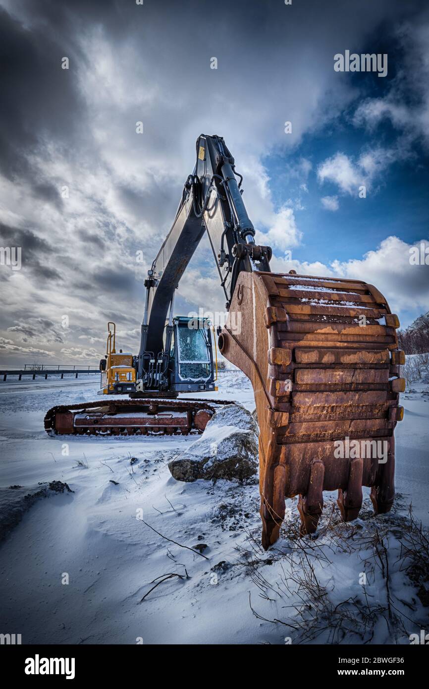 Old excavator in winter Stock Photo