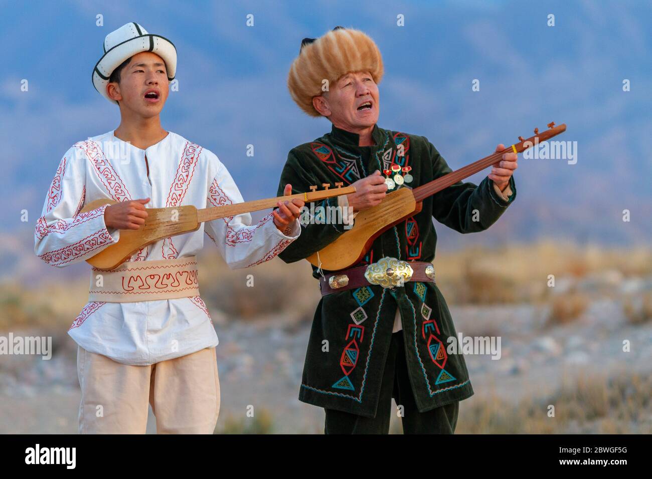 Kyrgyz musicians playing traditional musical instrument known as Komuz, in Issyik Kul, Kyrgyzstan Stock Photo