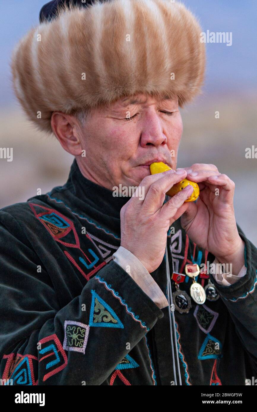 Kyrgyz musician plays traditional musical instrument known as Choor, in Issyk Kul, Kyrgyzstan Stock Photo