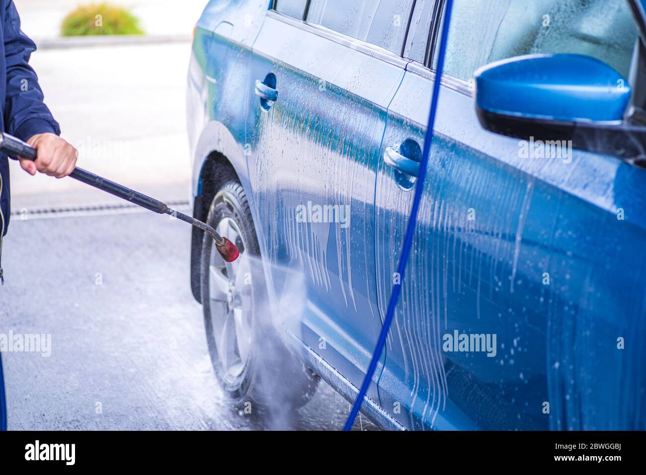 Cleaning Car Using High Pressure Water.Manual car wash with pressurized