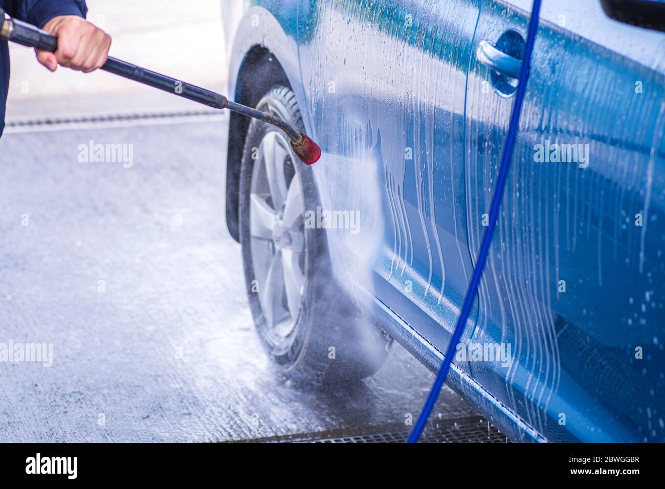 Cleaning Car Using High Pressure Water.Manual car wash with pressurized