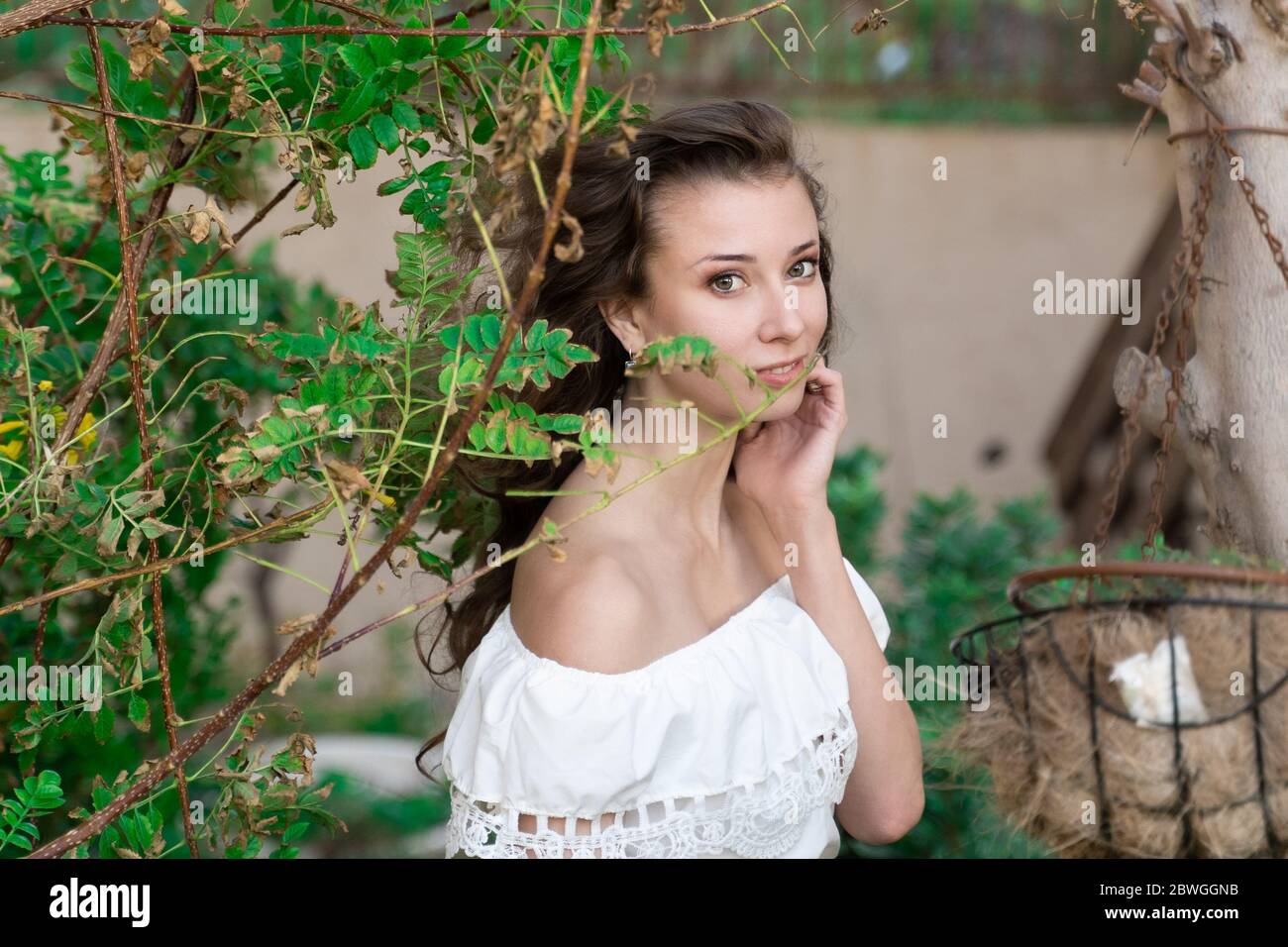 Summer beautiful girl in a white dress between green plants Stock Photo ...