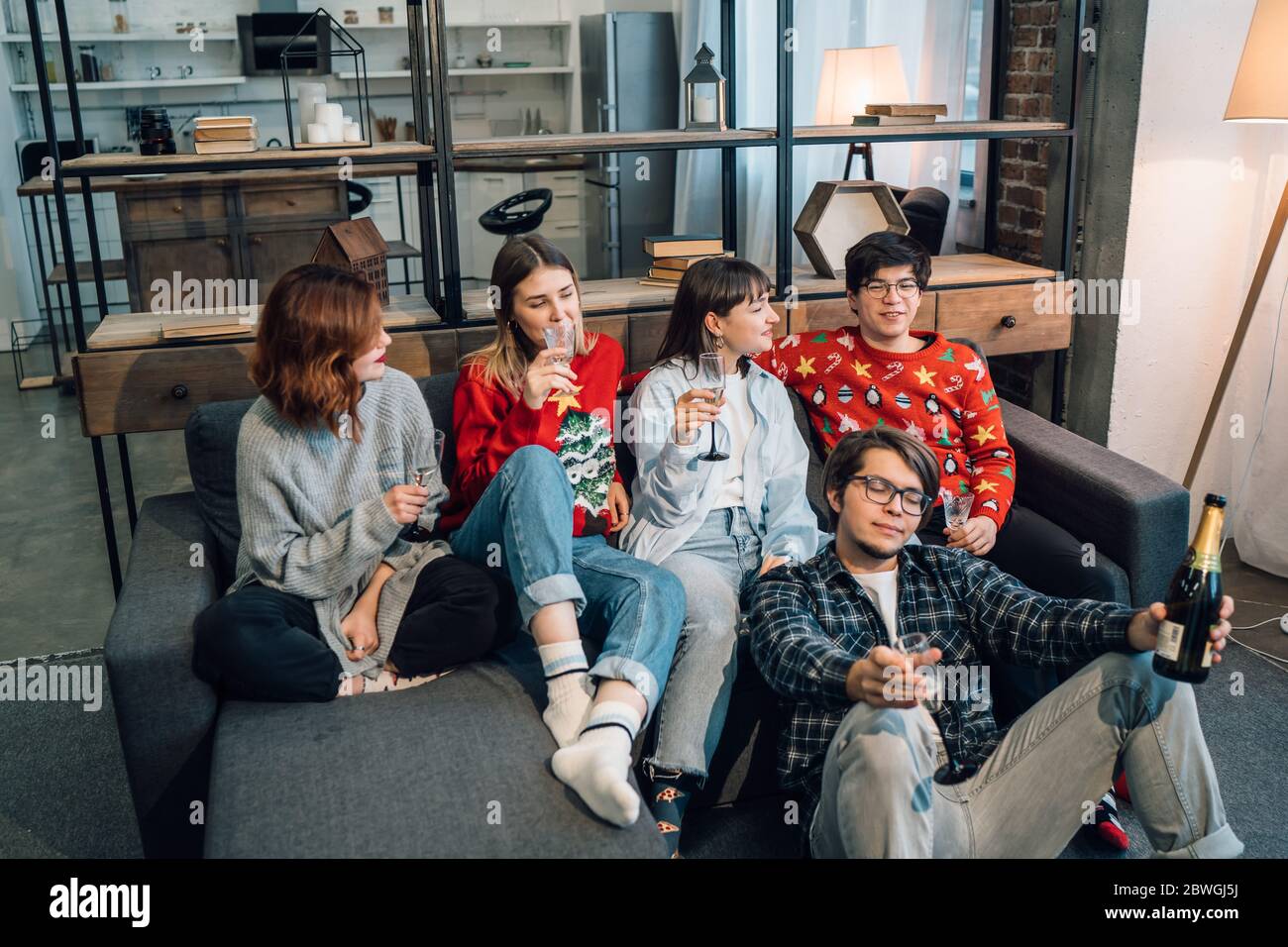 Group friends talking sitting in a couch in the living room Stock Photo ...