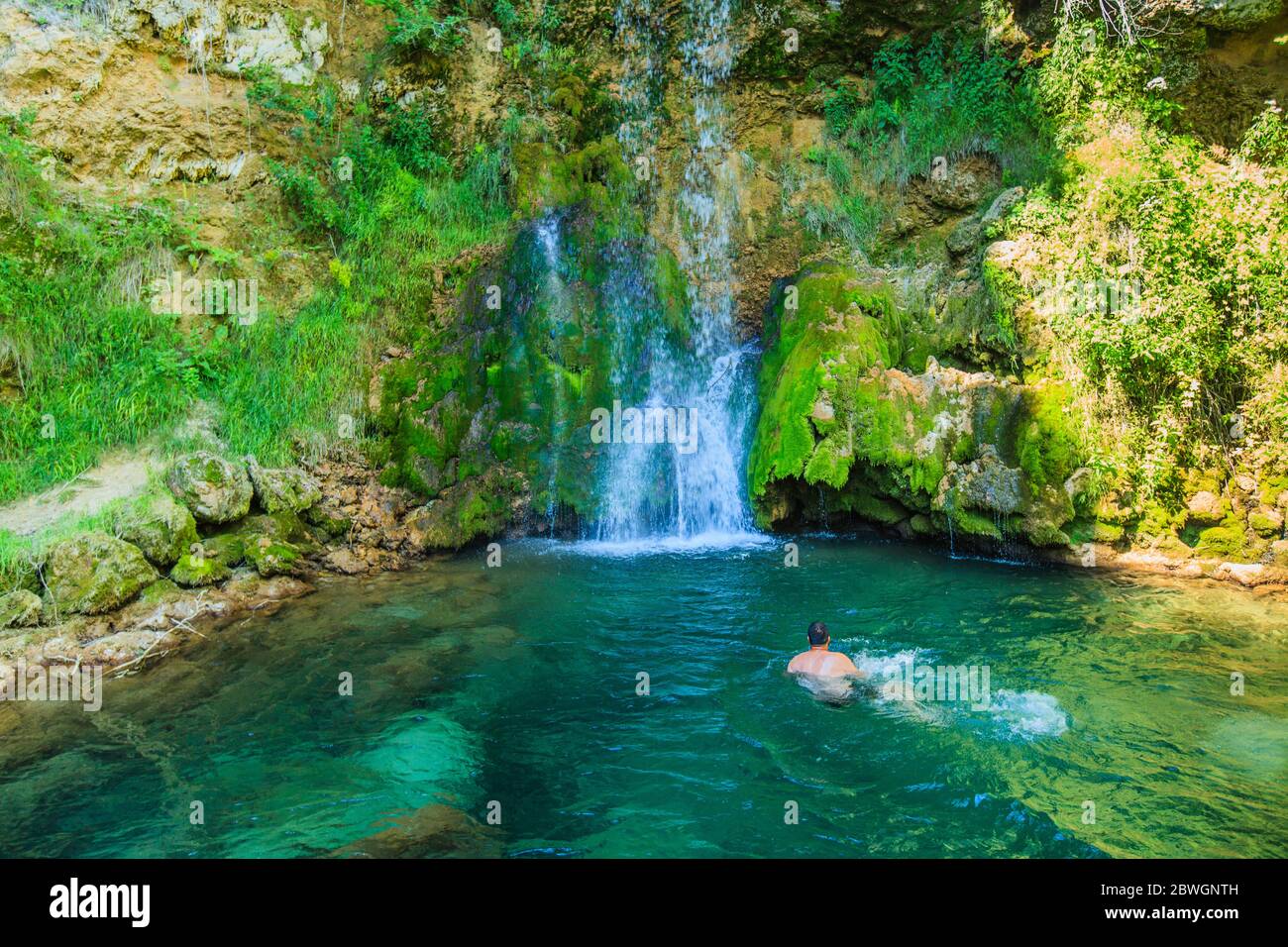 https://c8.alamy.com/comp/2BWGNTH/man-swimming-in-clear-and-cold-water-in-natural-pool-under-waterfall-at-forest-refresh-on-summer-hot-day-in-nature-serbia-europe-2BWGNTH.jpg