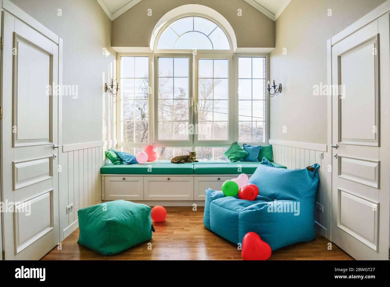 Relax zone in privat house with big window, pouf and bag chair Stock Photo