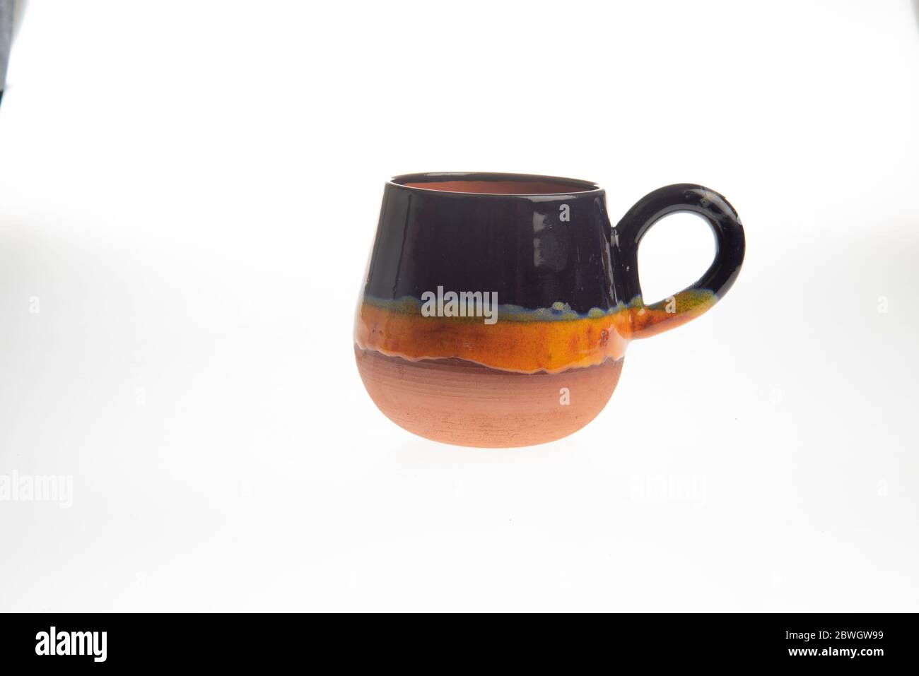 colorful handmade ceramic coffee cups on white background Stock Photo