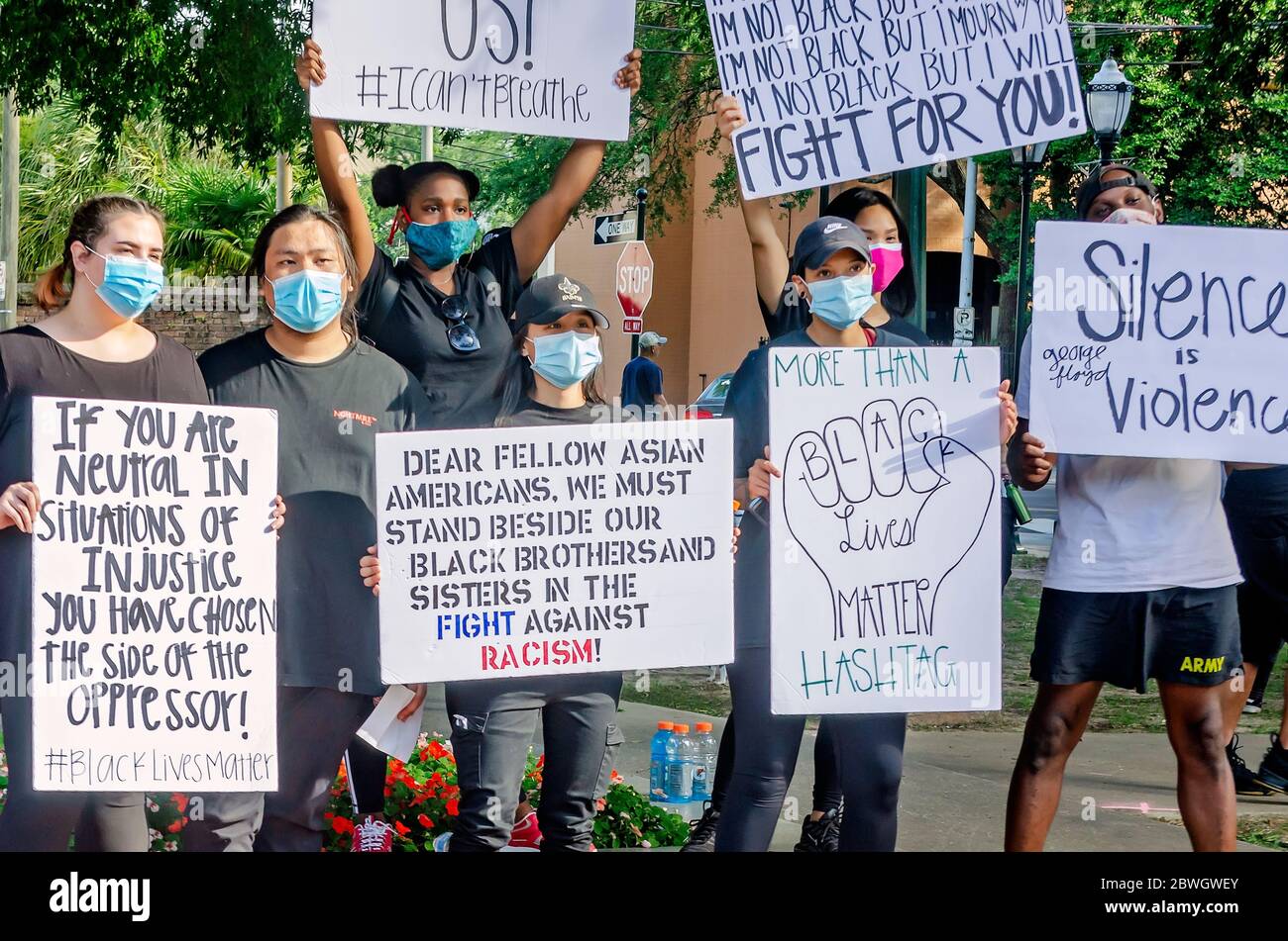 Asian-Americans, African-Americans, and Caucasians protest during a vigil for George Floyd at Cathedral Square, May 31, 2020, in Mobile, Alabama. Stock Photo