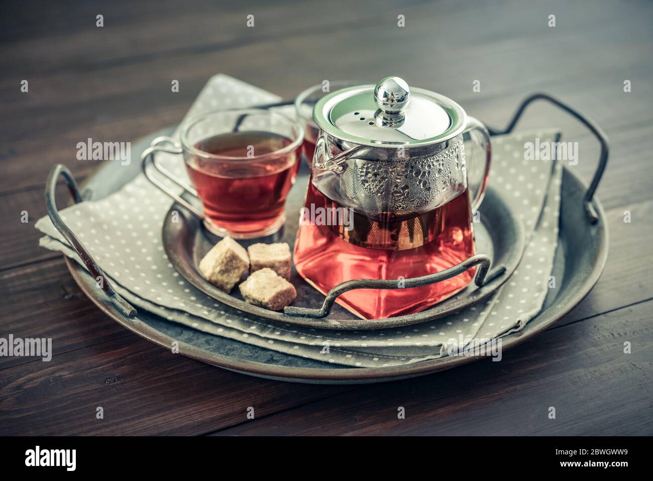 Tea set with hot tea and breakfast on a white wooden mat on the table Stock  Photo by ©belchonock 102145306